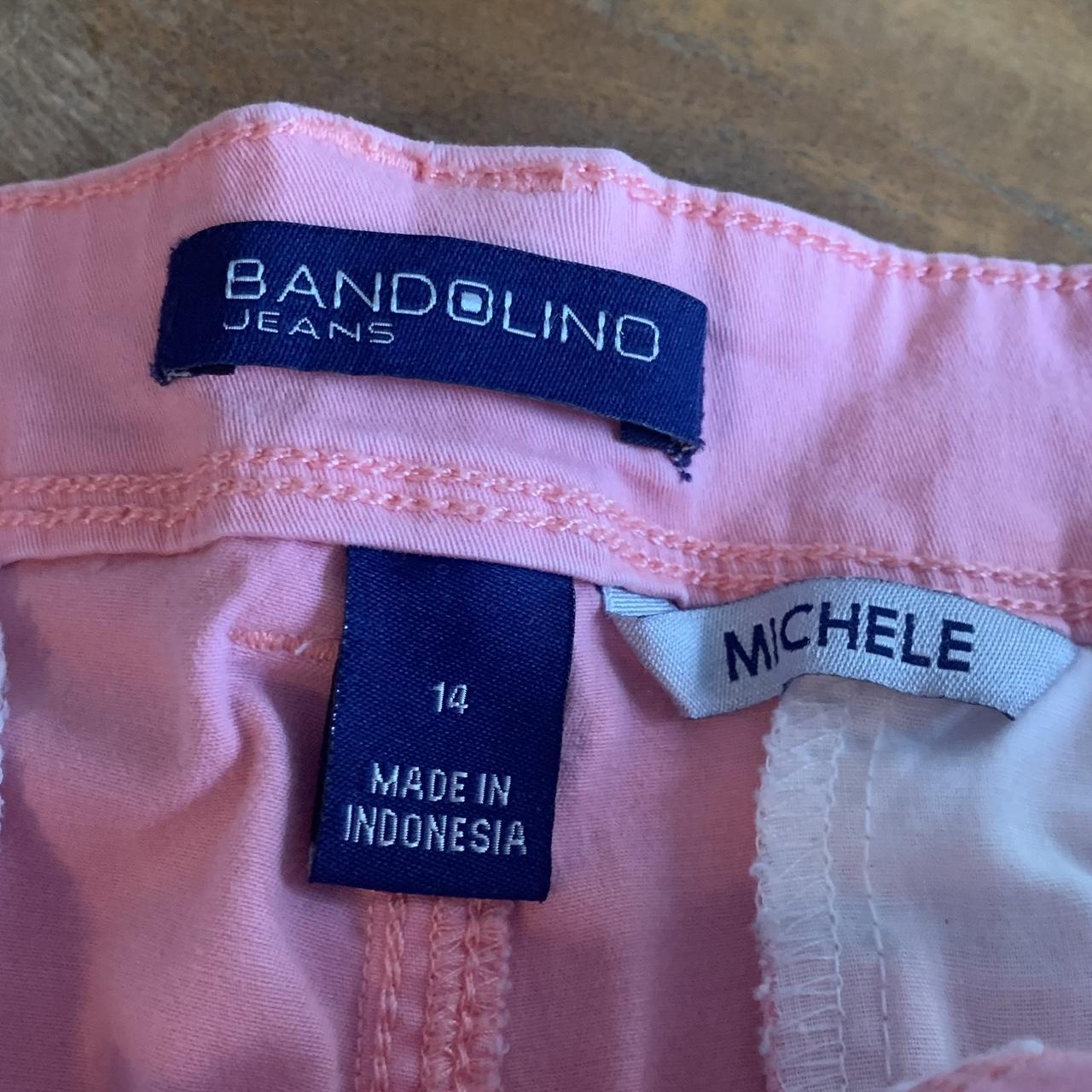 Ripped pink jean shorts brand is Bandolino. Good