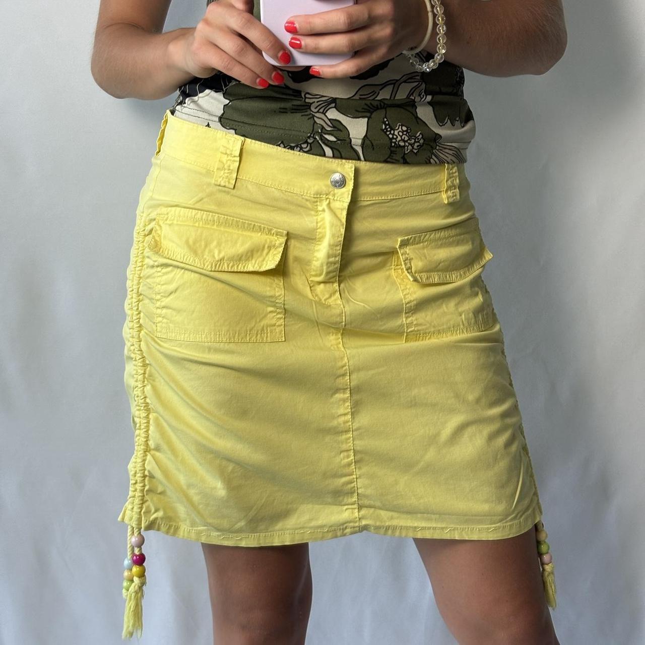 Vintage yellow cargo skirt with beads and pockets on. Depop