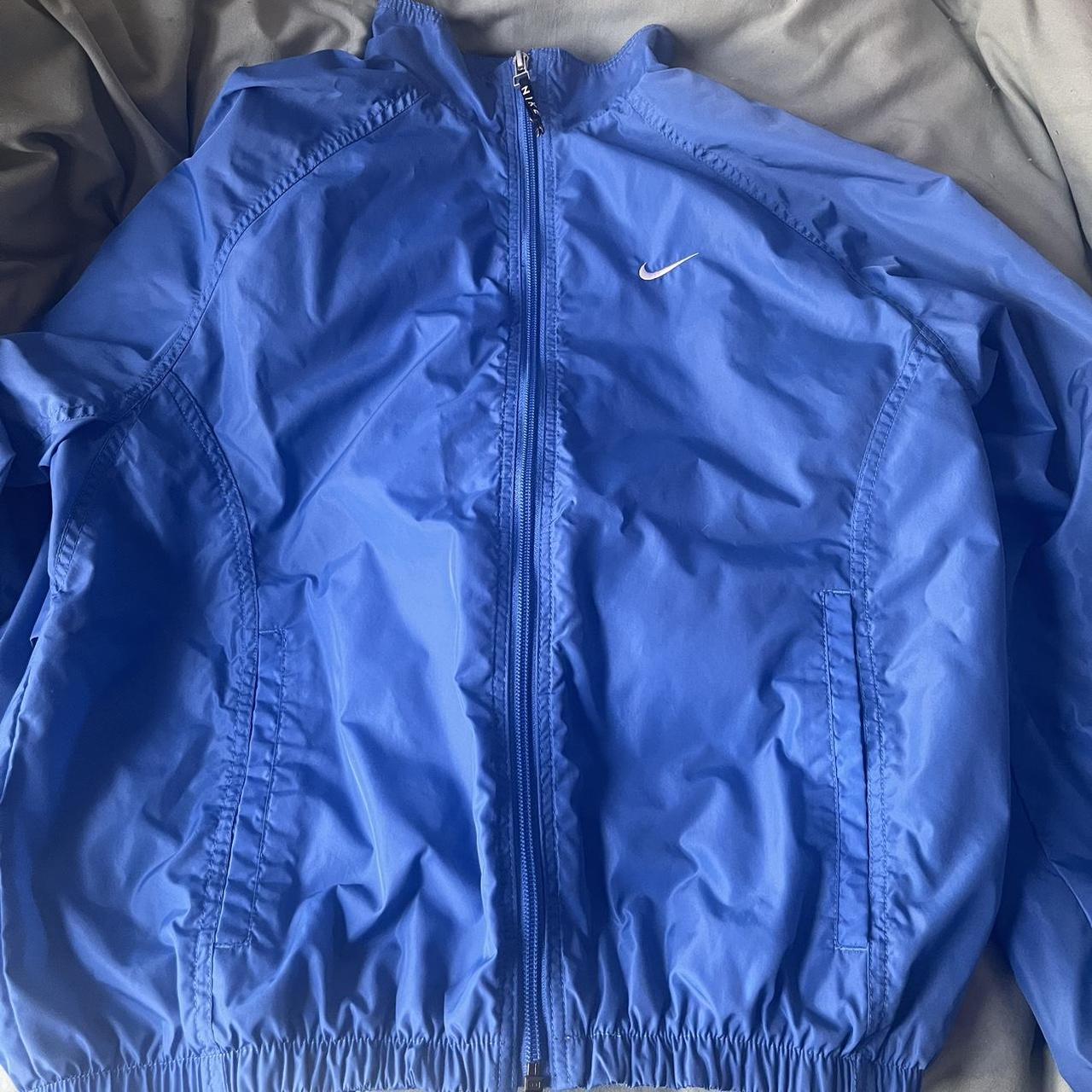 blue nike windbreaker fit is cropped at waistline,... Depop