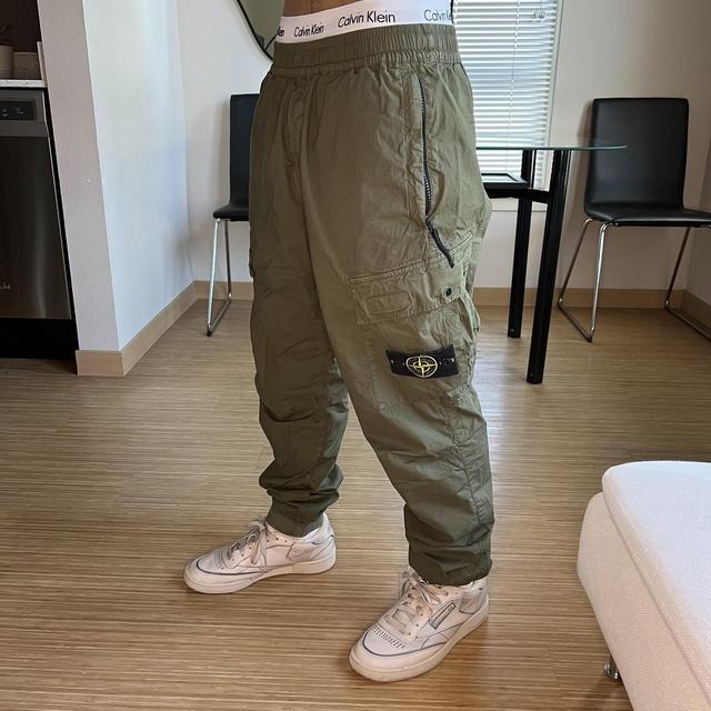 green stone island cargo pants type re-t in size 33.... - Depop