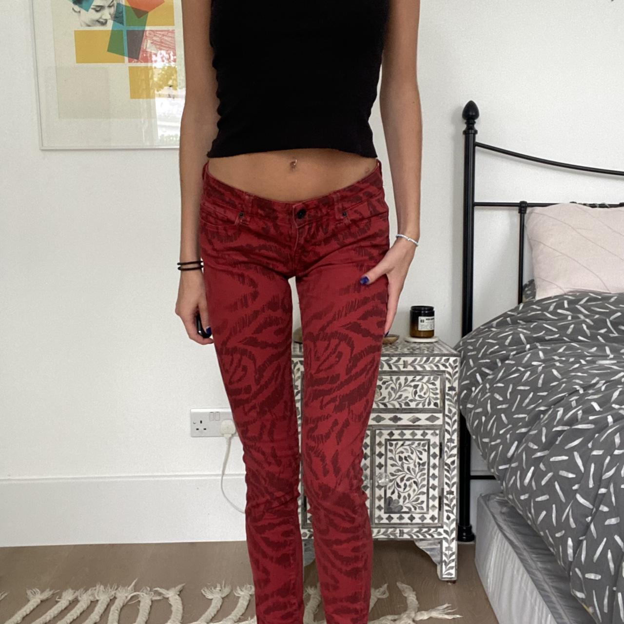 Low rise dark red jeans with black tiger print... - Depop