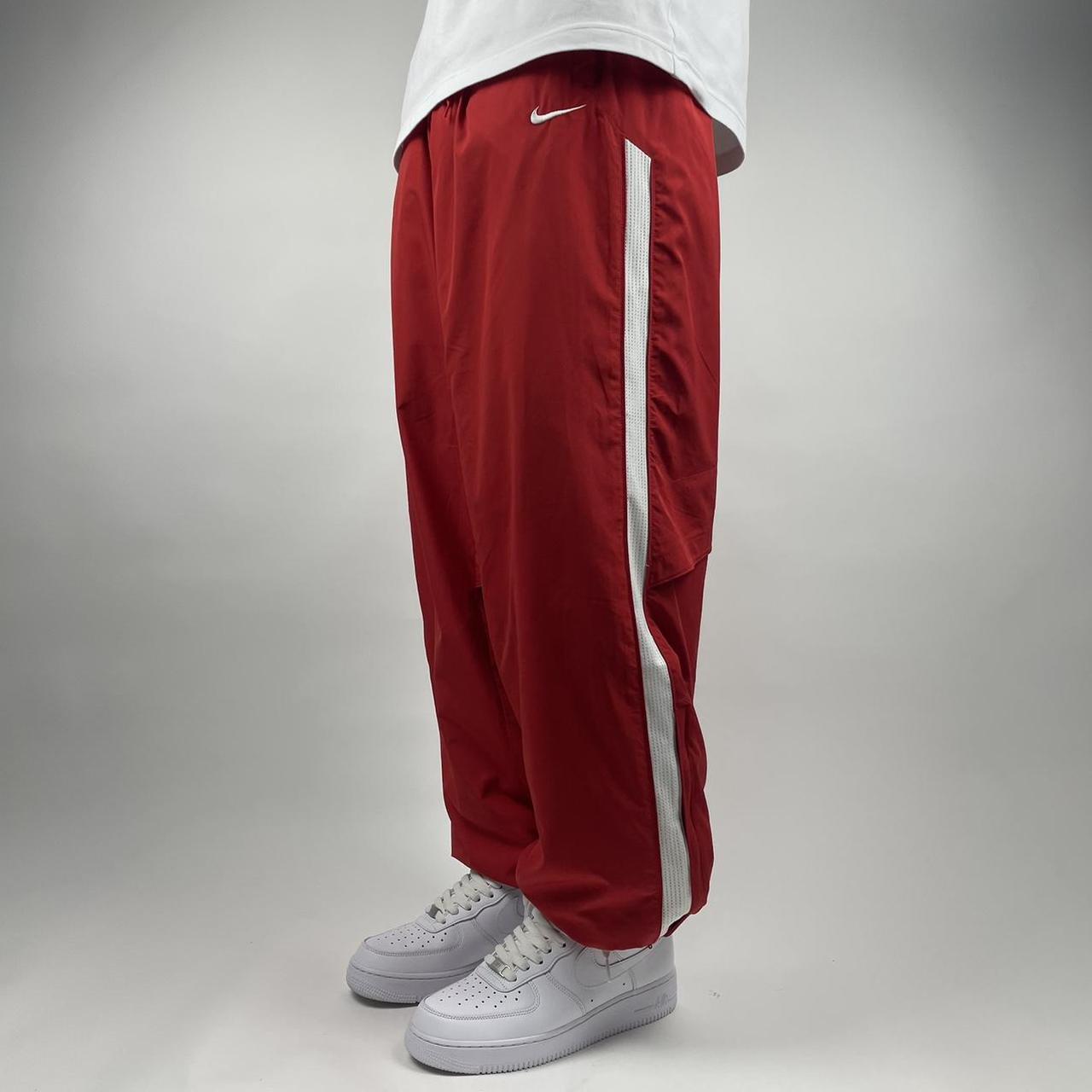 Y2k Nike track pants with side stripes model off - Depop