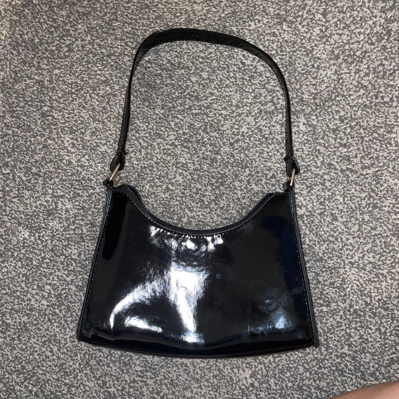 black bag with gold zip and connectors, in good... Depop