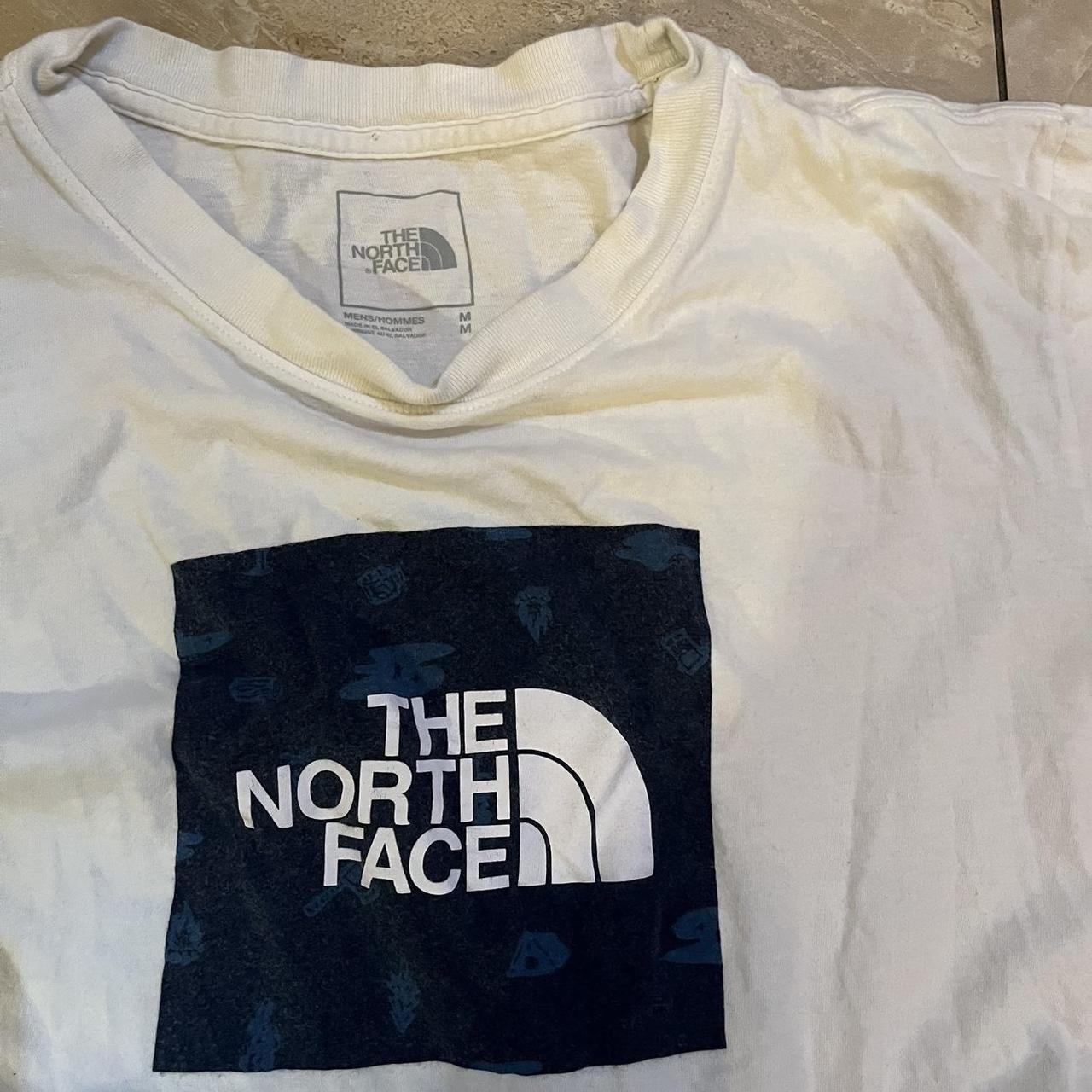 White north face tee shirt with blue logo! Size... - Depop