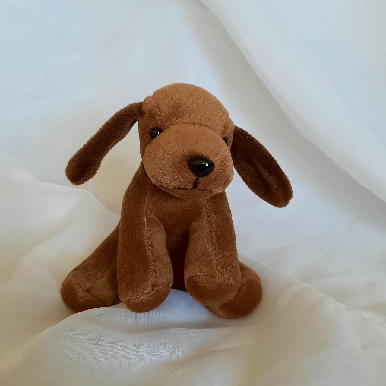 Cute little plush brown puppy with floppy ears and