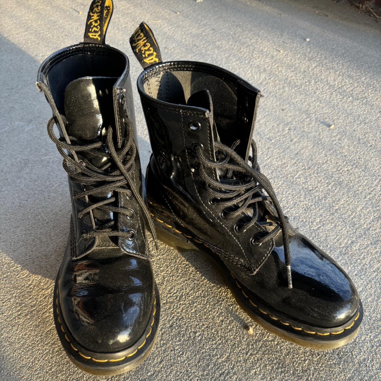 Black boots with yellow tag best sale