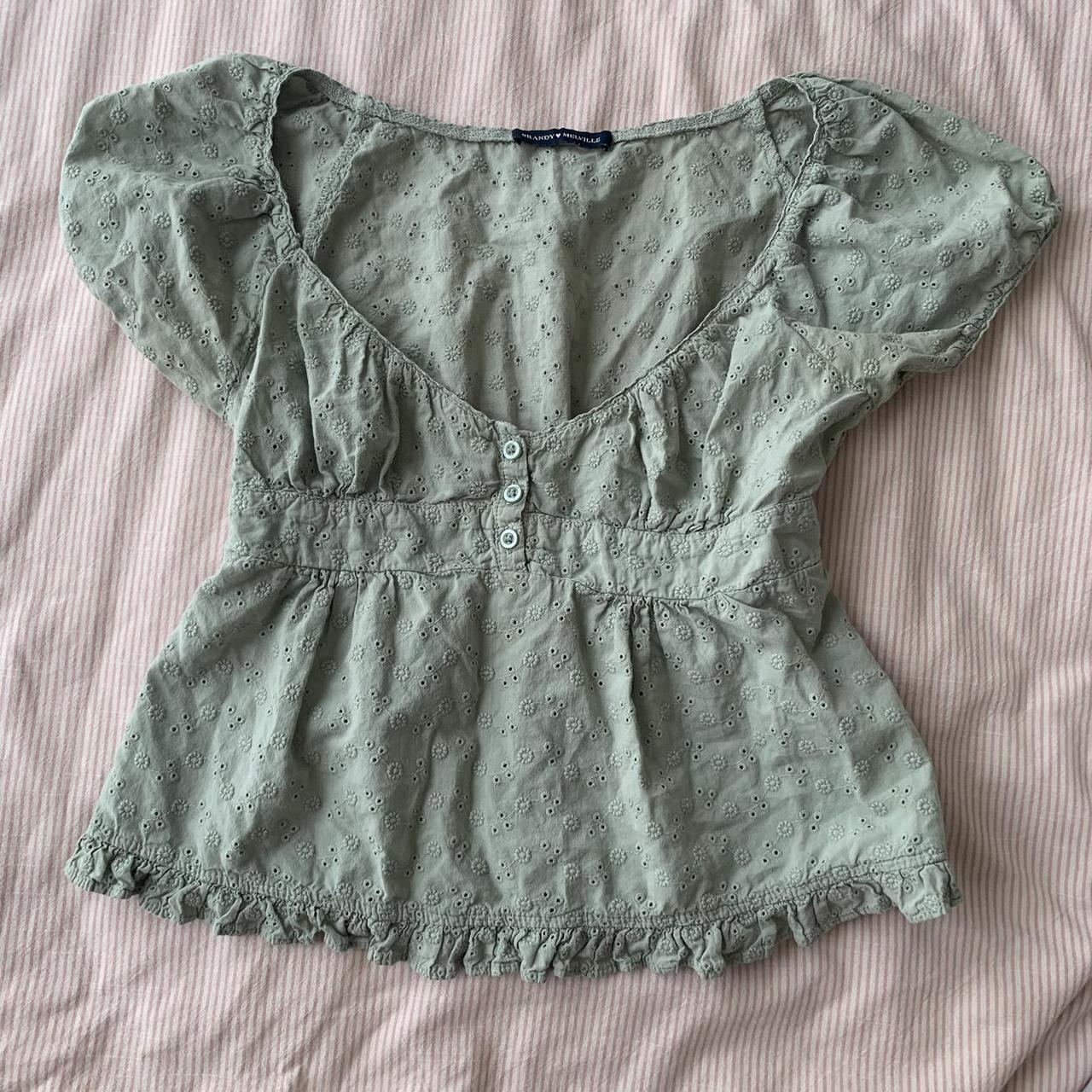 Brandy Melville babydoll top with flower/eyelet... Depop