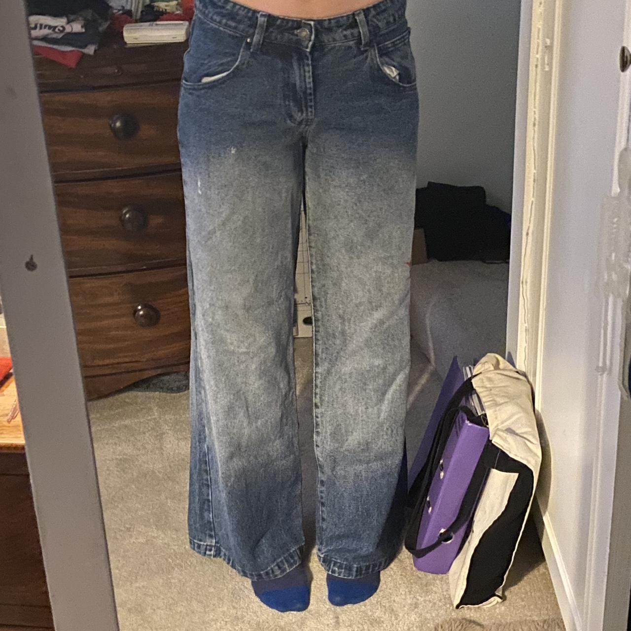low rise light wash jeans with red print on one leg - Depop