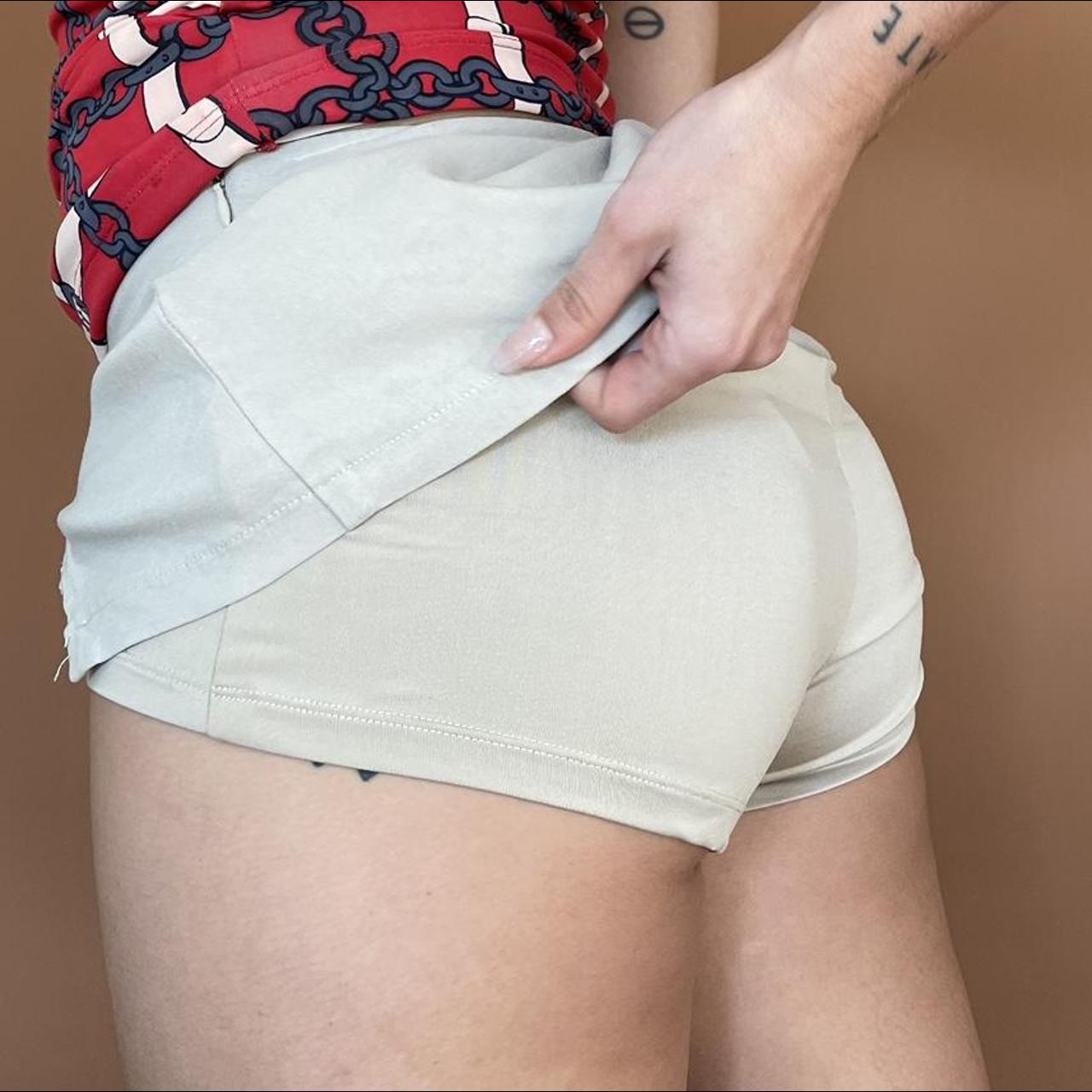 Cream mini skort with v waistline. In built shorts... - Depop