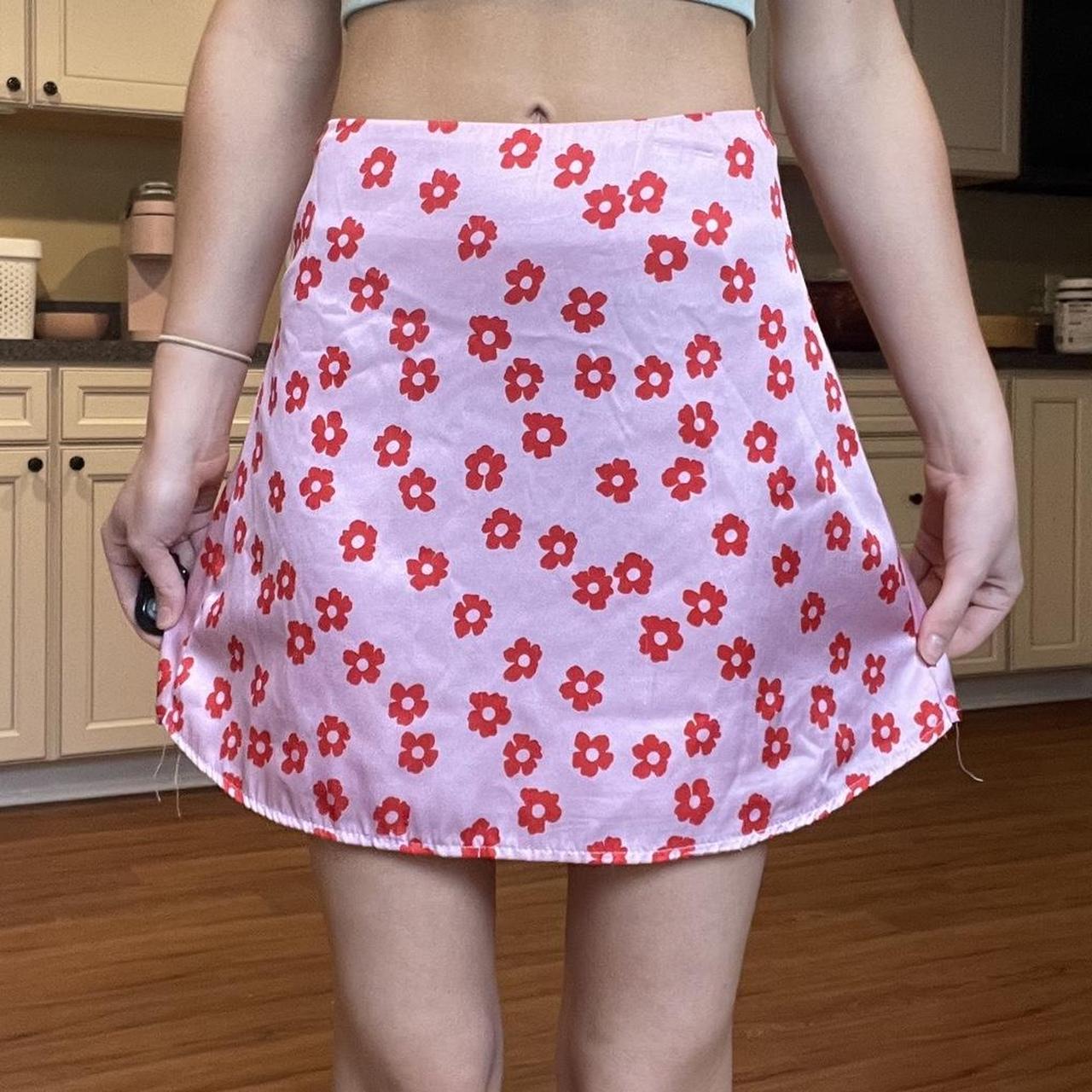 Pink skirt with outlet red flowers