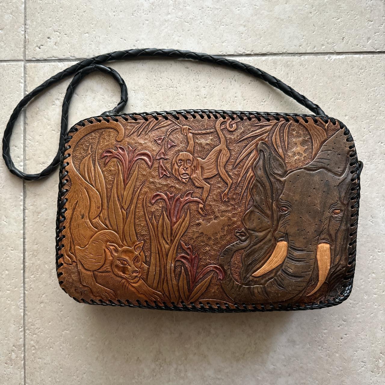 Pretty Penny Clothing - Vintage tooled leather purse with horse detail.  Saddle closurewith metal. Adjustable tooled leather strap with brass +  stone detail. Good vintage condition total length with strap “29” height