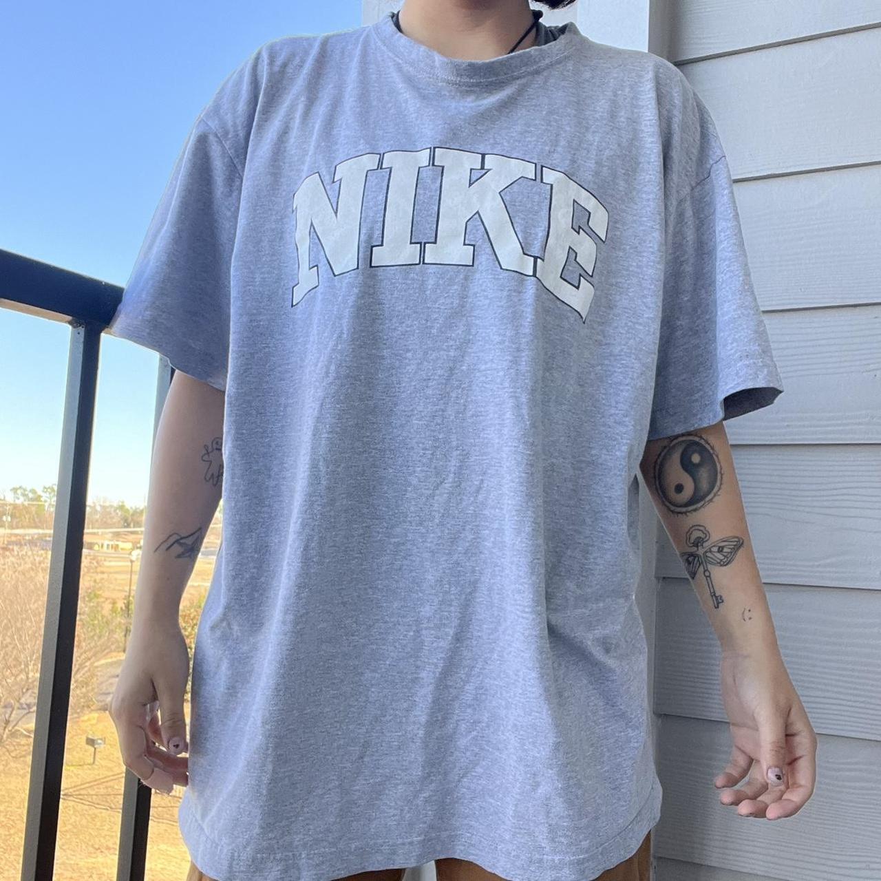 green and gray nike shirt