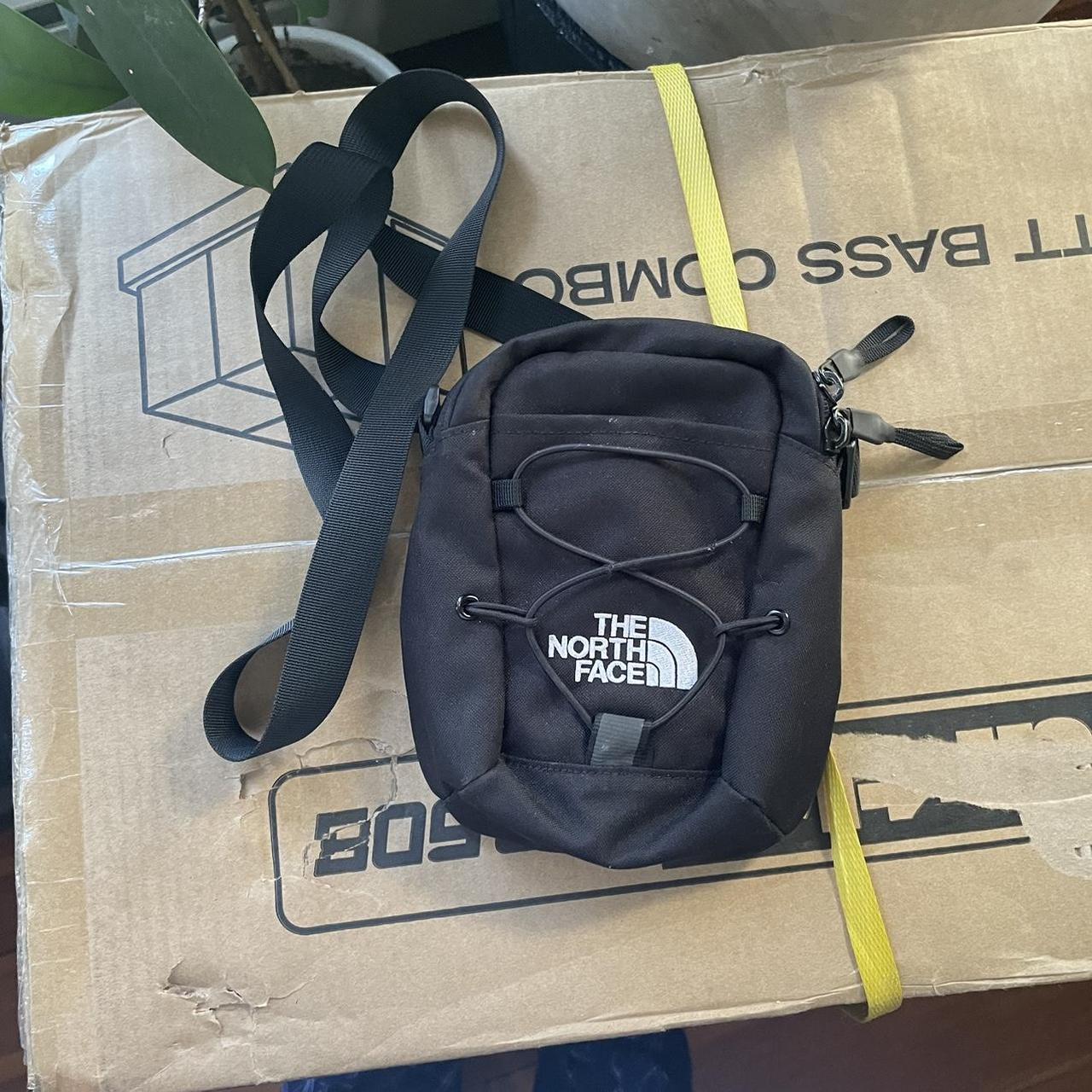 The North Face crossbody black bag. All zippers work... Depop