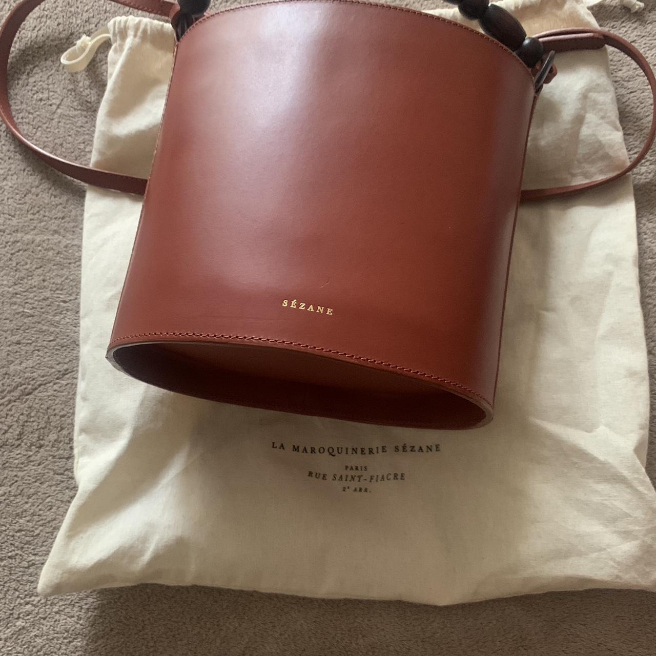 Sezane leather bucket bag worn handful of