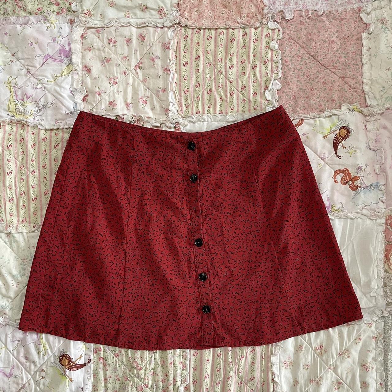General pants beyond her red patterned skirt. red... Depop