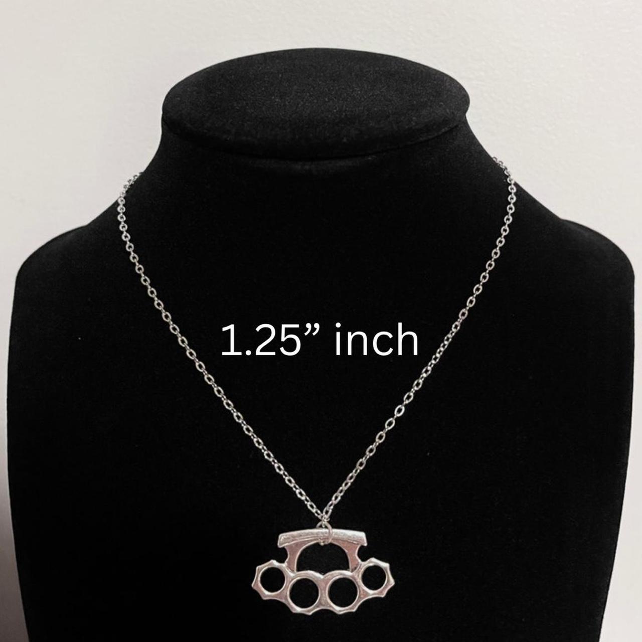 zinc alloy metal brass knuckles necklace. pendant is... Depop