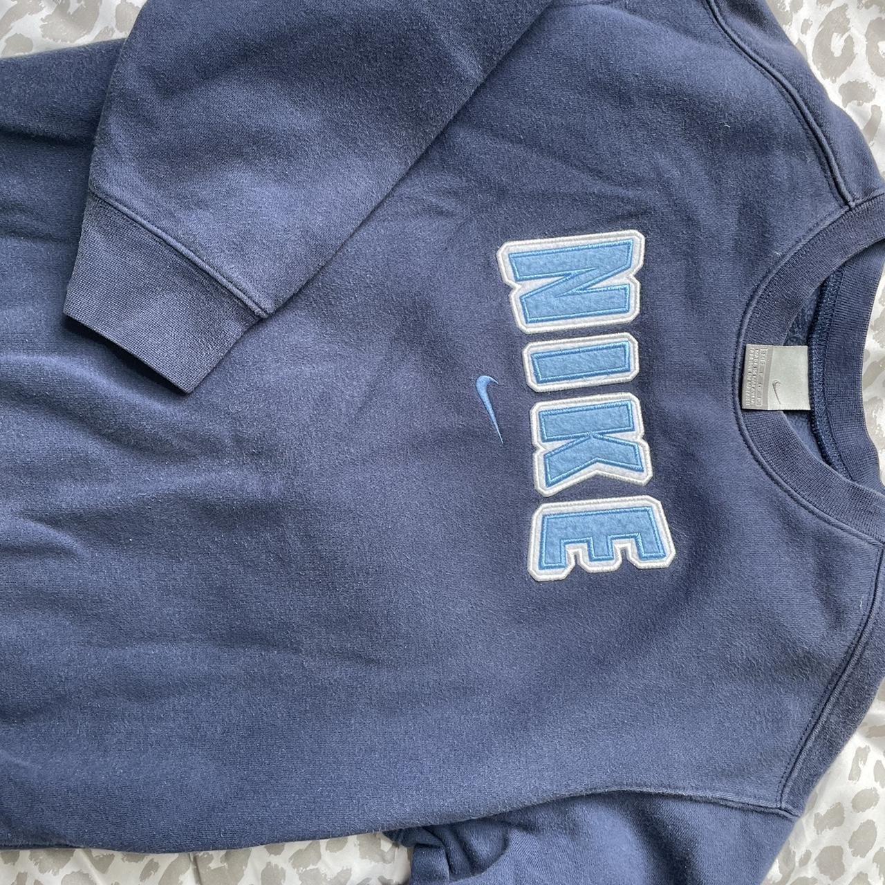 navy blue center swoosh nike crew neck only flaw is... - Depop