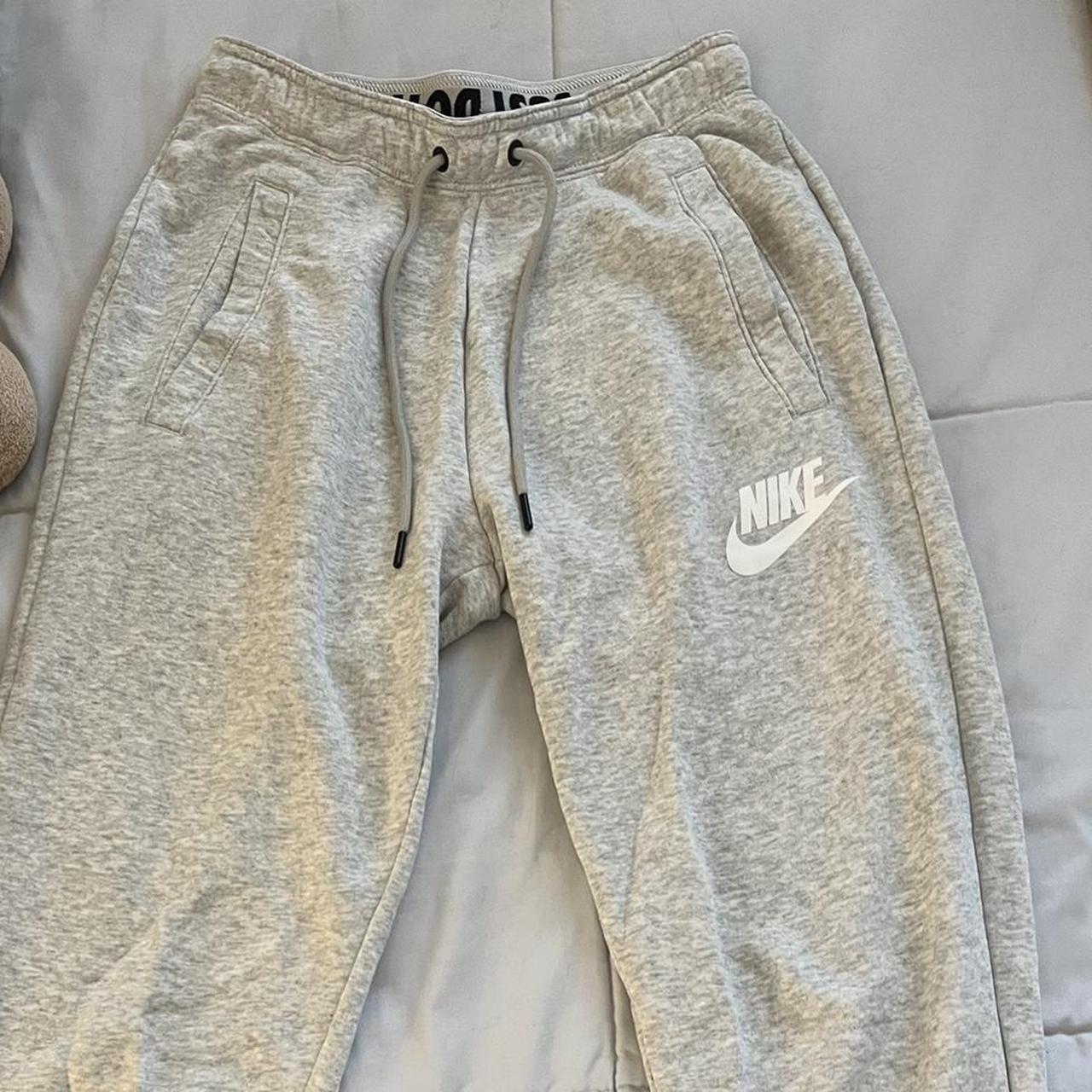 light grey nike sweatpants tight at the end of the... - Depop