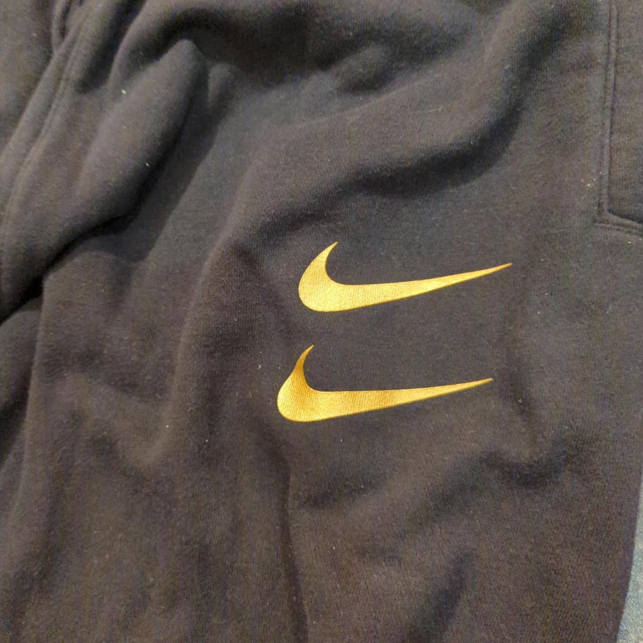 Black and gold Nike tracksuit bottoms (also selling... Depop