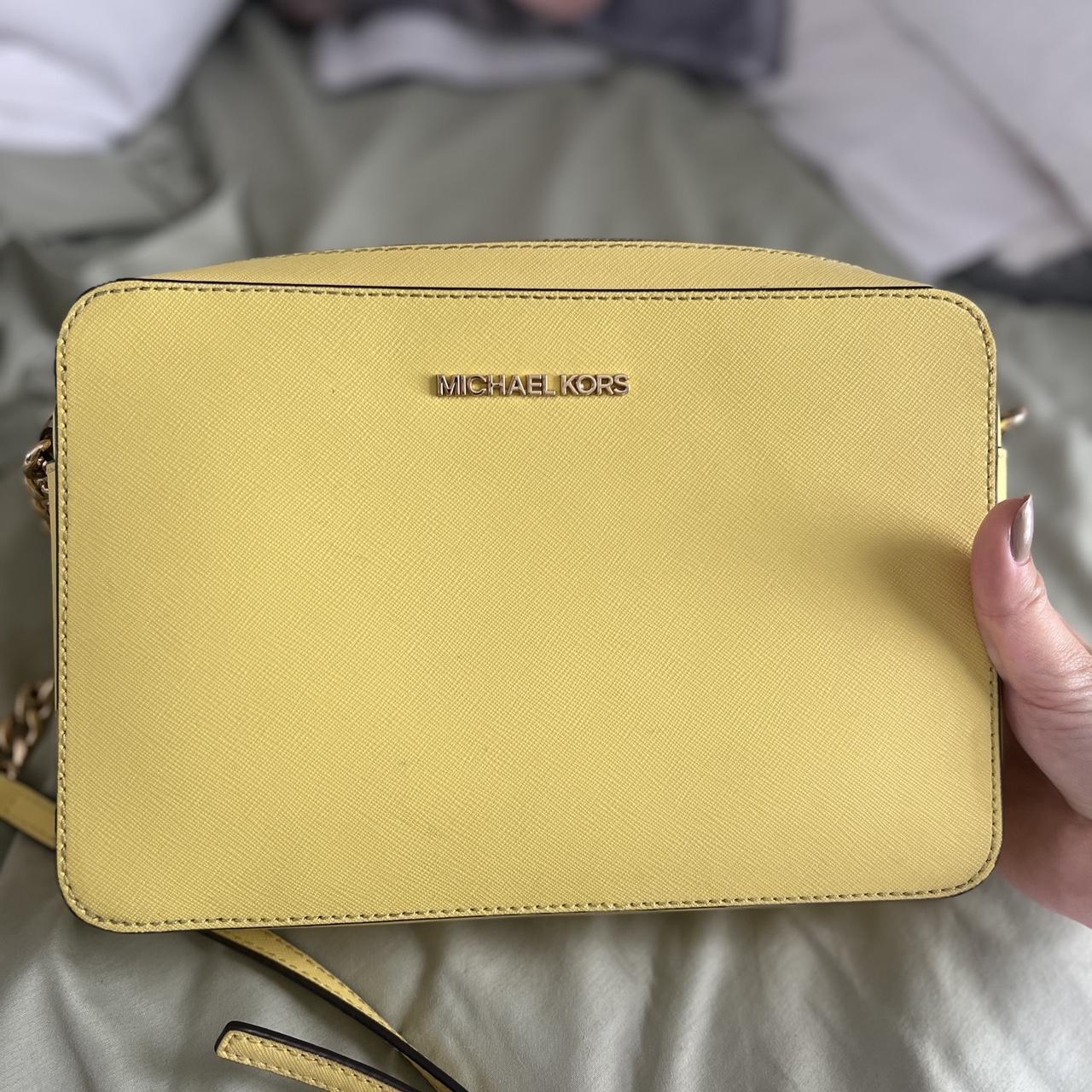 Yellow Michael Kors purse with gold accents. Small. Depop