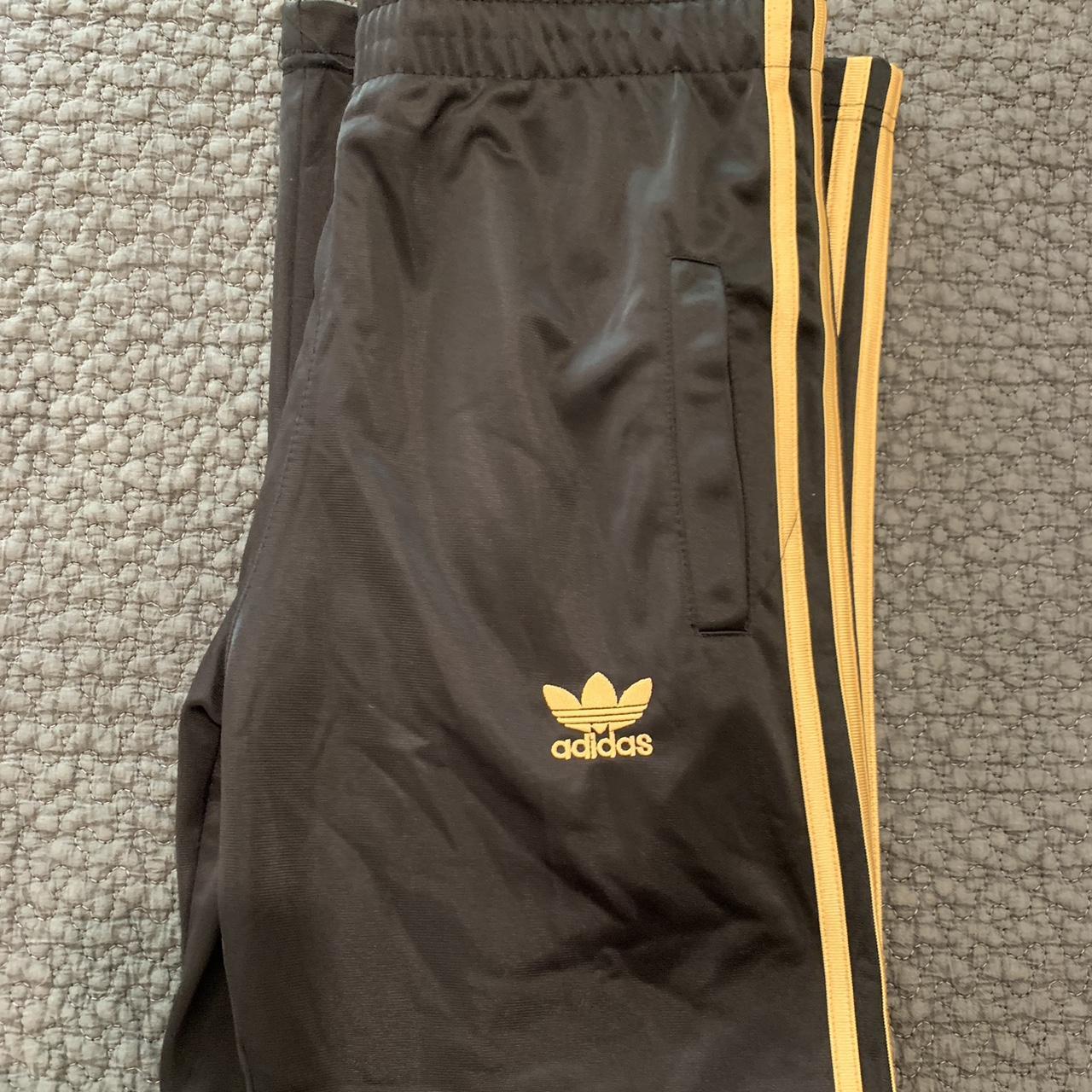 Vintage Adidas black sweatpants with gold trimming... - Depop