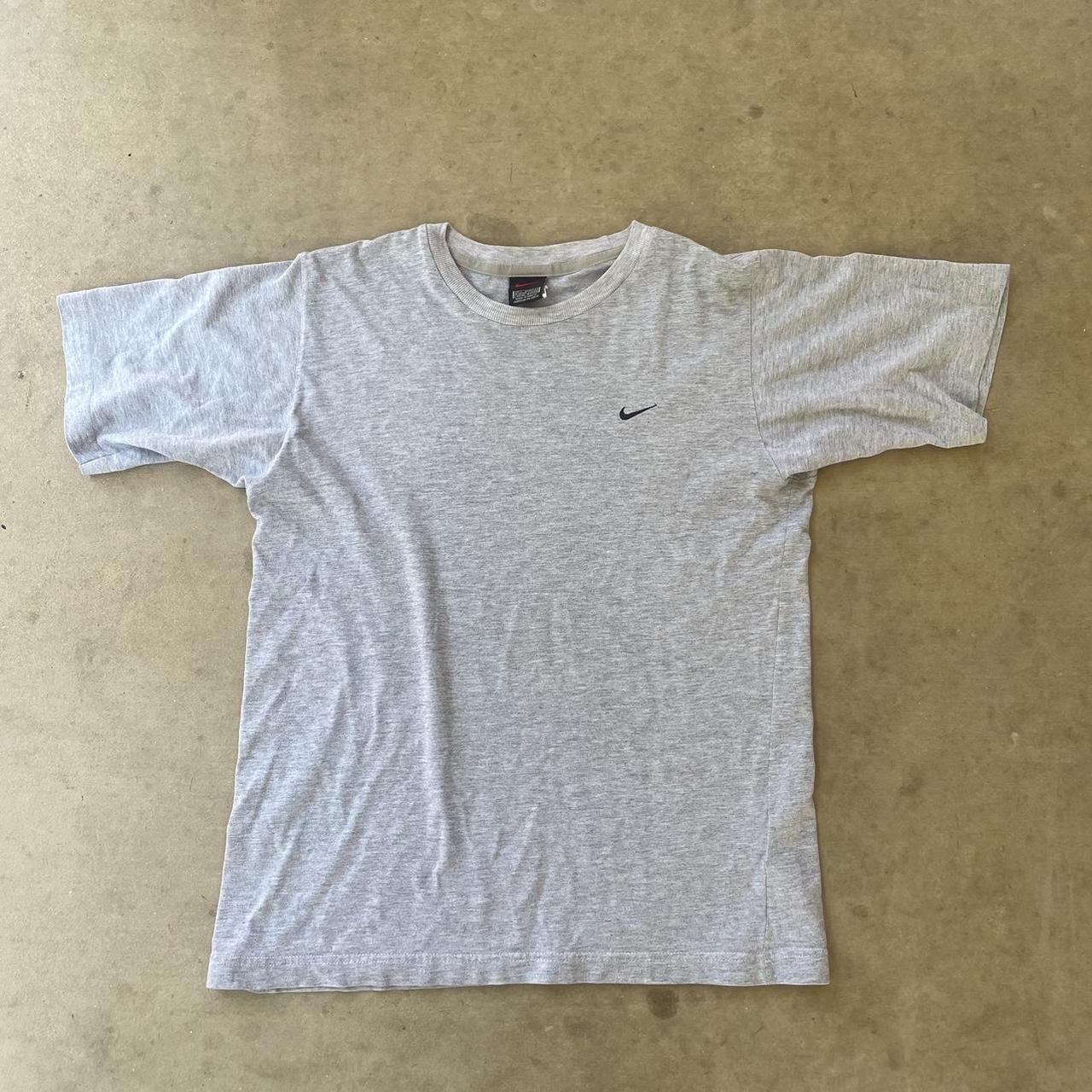black nike shirt with orange swoosh
