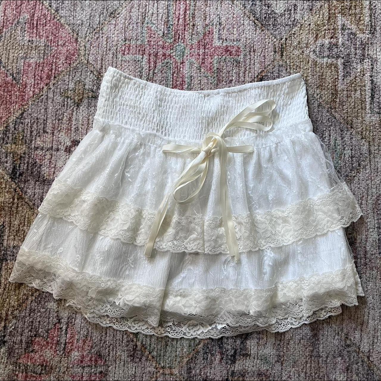 White lace mini skirt. Bow in front - Depop