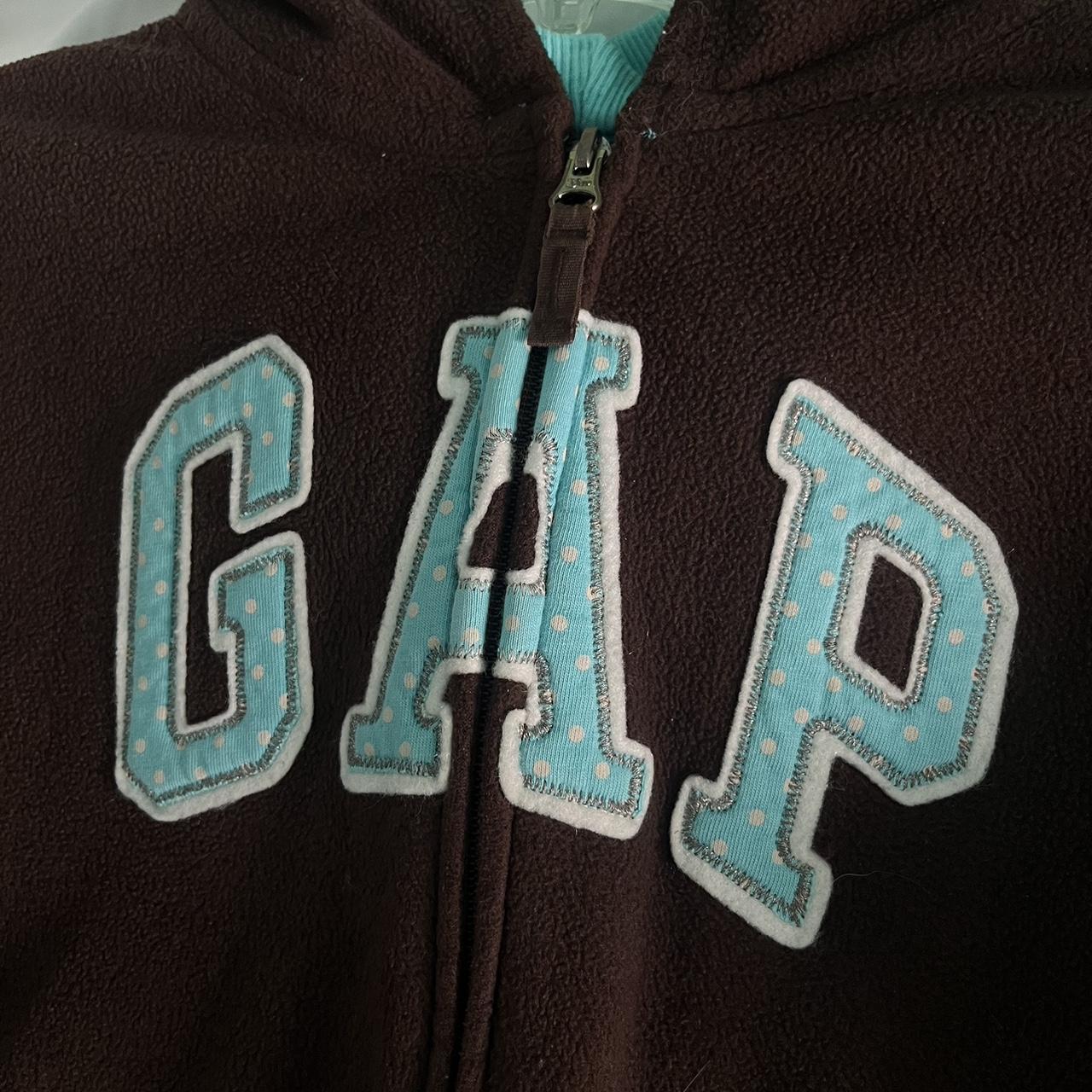 brown gap zip up hoodie with blue details kids... Depop