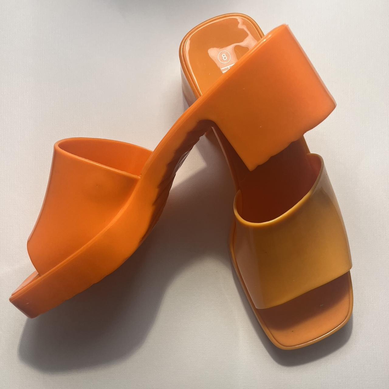Orange Jelly sandals. One shoe is a lighter shade of... Depop
