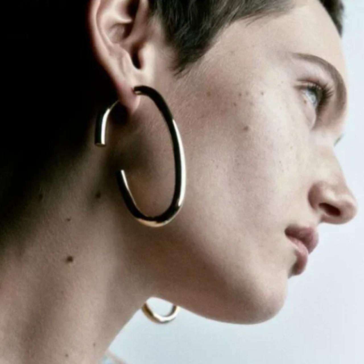 Metal brand store earrings