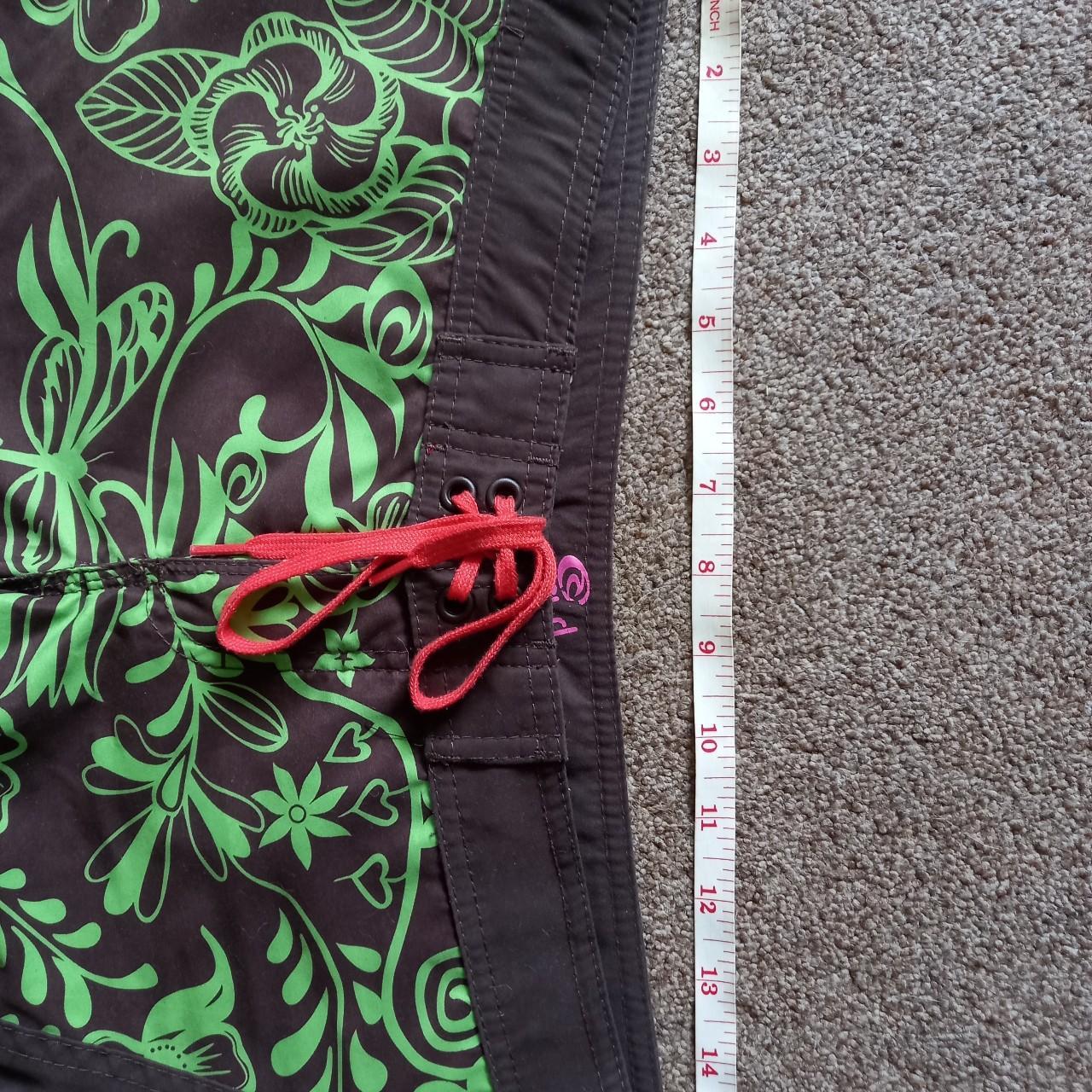 Brown and lime green board shorts from Rip Curl,... Depop