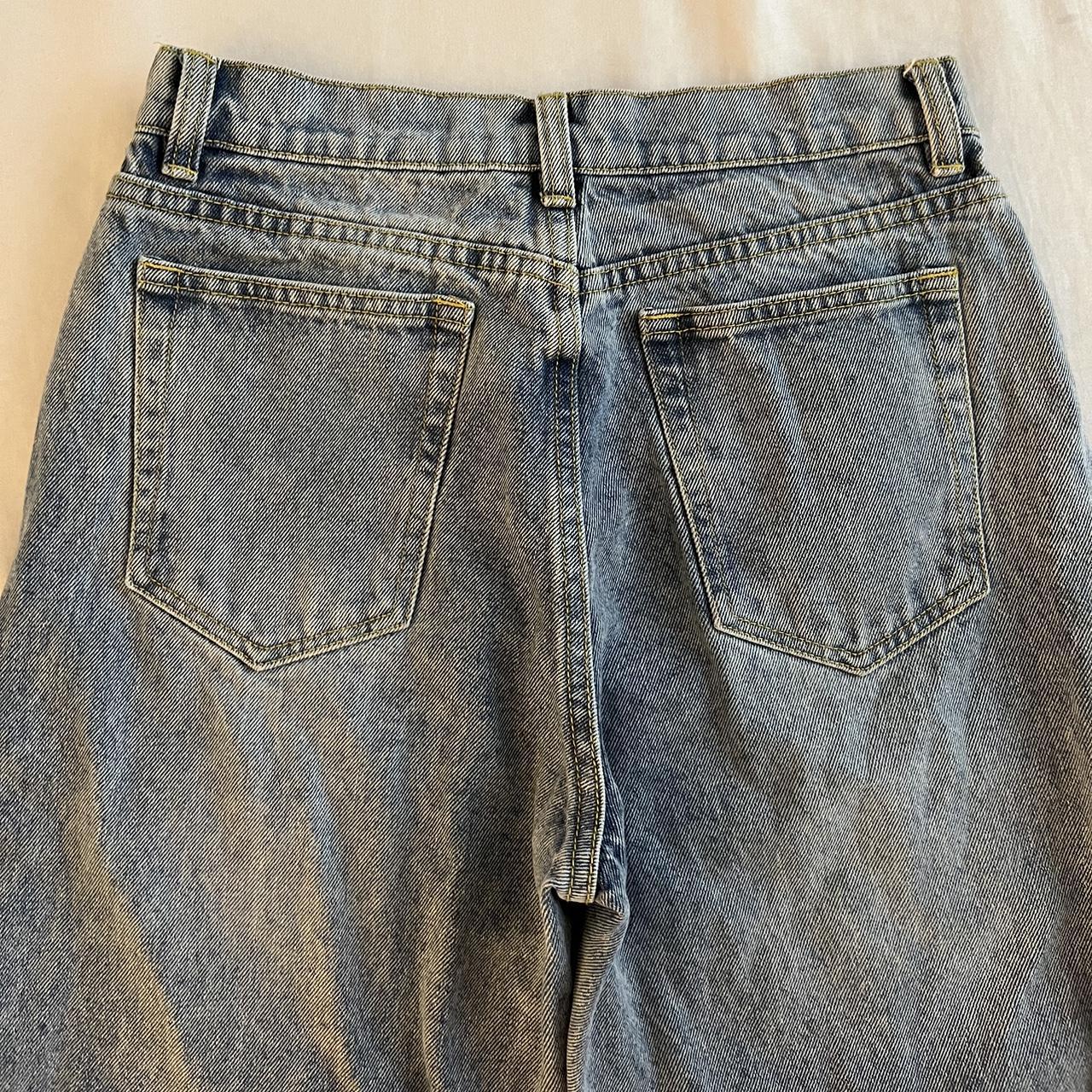 The Kript vintage style mom jeans with distressing and cross over