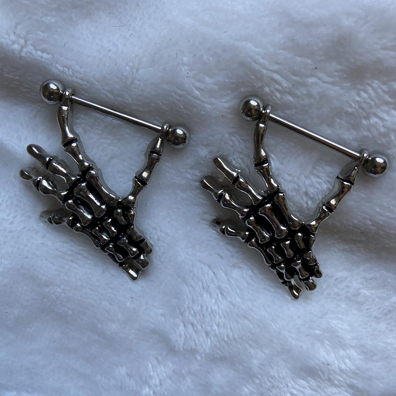 skeleton hand nipple piercings chrome/silver bought... - Depop