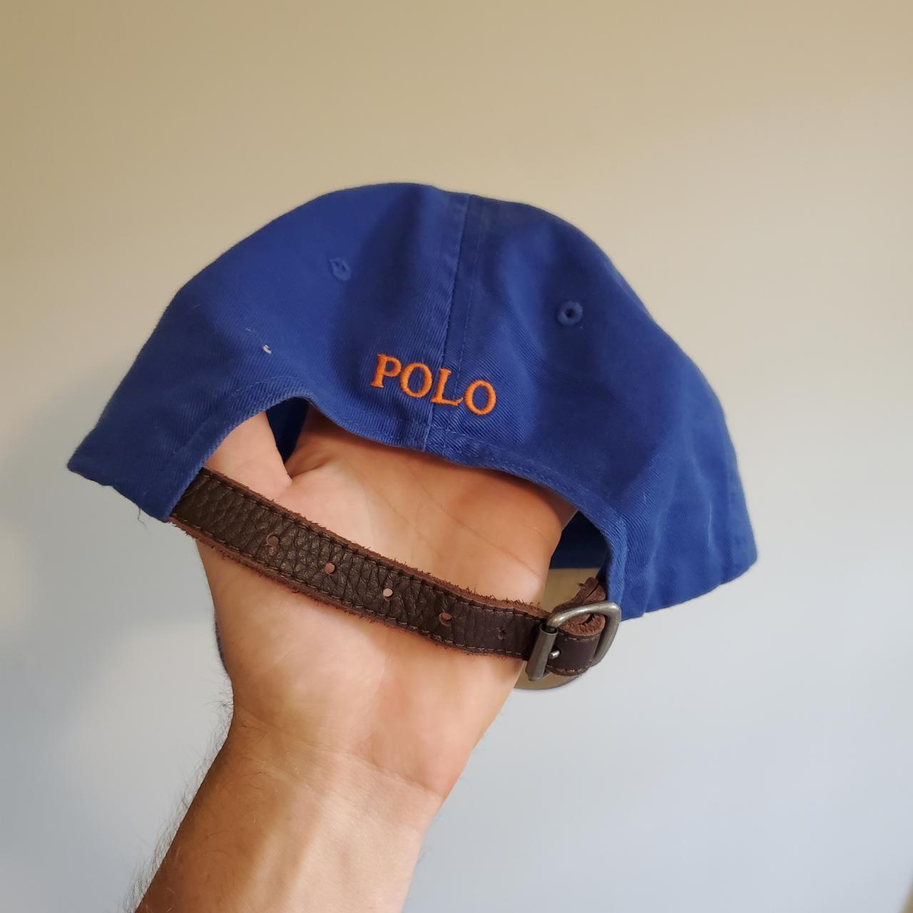 Navy blue polo hat with shop leather strap