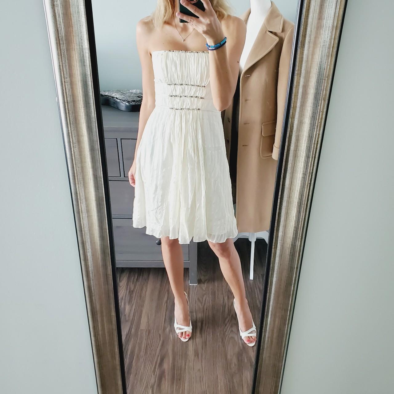 This beautiful BCBGMaxAzria ivory dress is made of