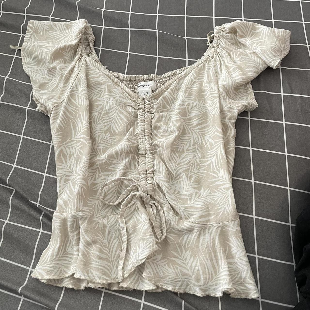 Tan and white floral crop top. Strings in the front... - Depop
