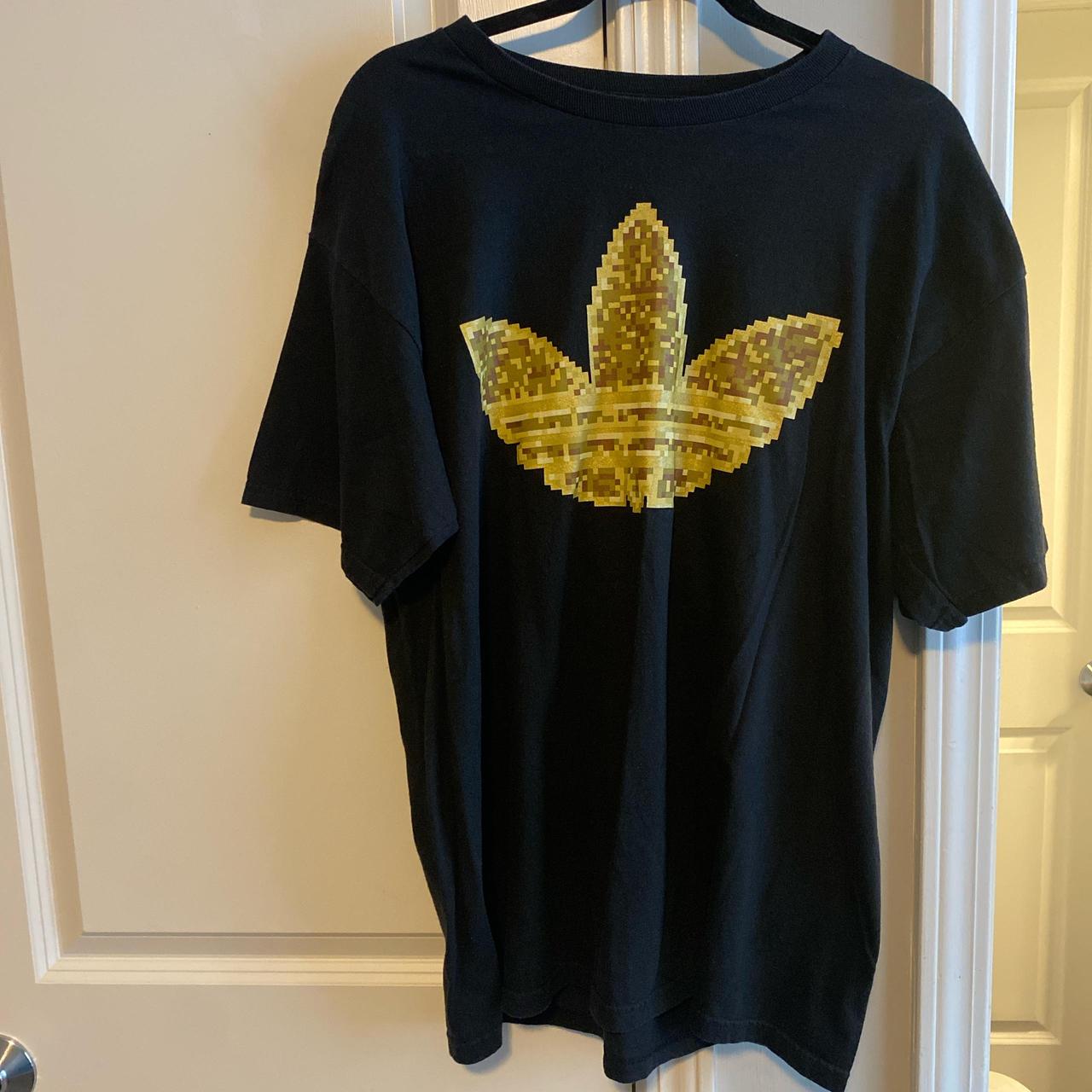 Adidas black and gold tshirt the Adidas symbol is. Depop