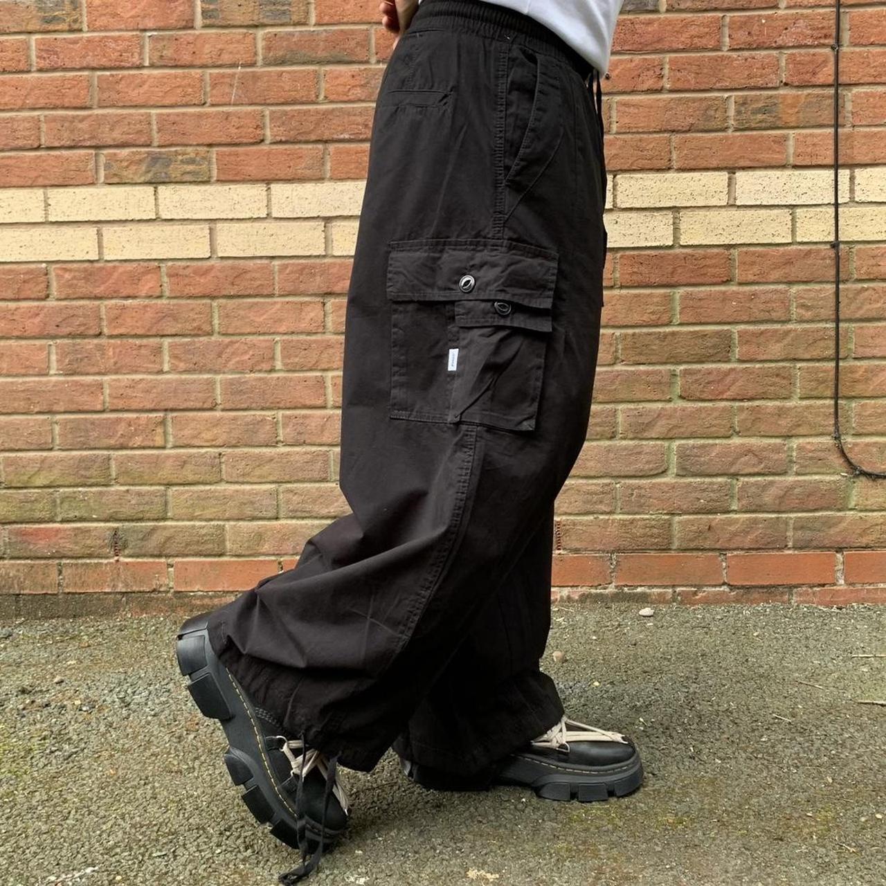 Black baggy parachute pants with side pockets