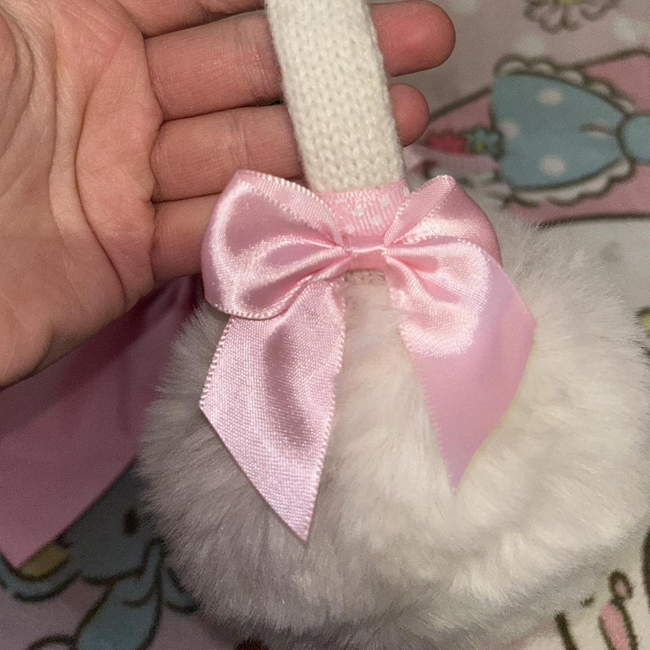 Fluffy white ear muffs with pink bows on either side... Depop