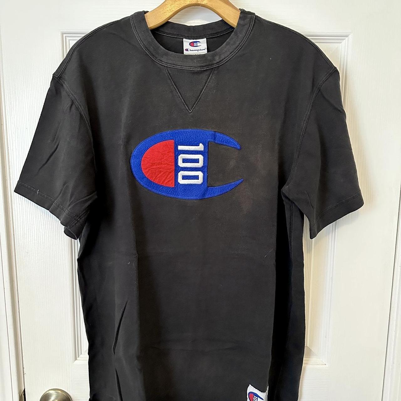 Champion 100 black and blue tshirt. Emblem is made