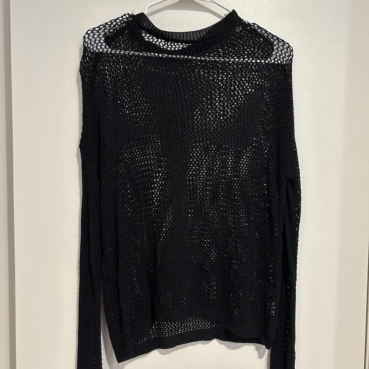 Black fishnet sweater with a raw hem cross design