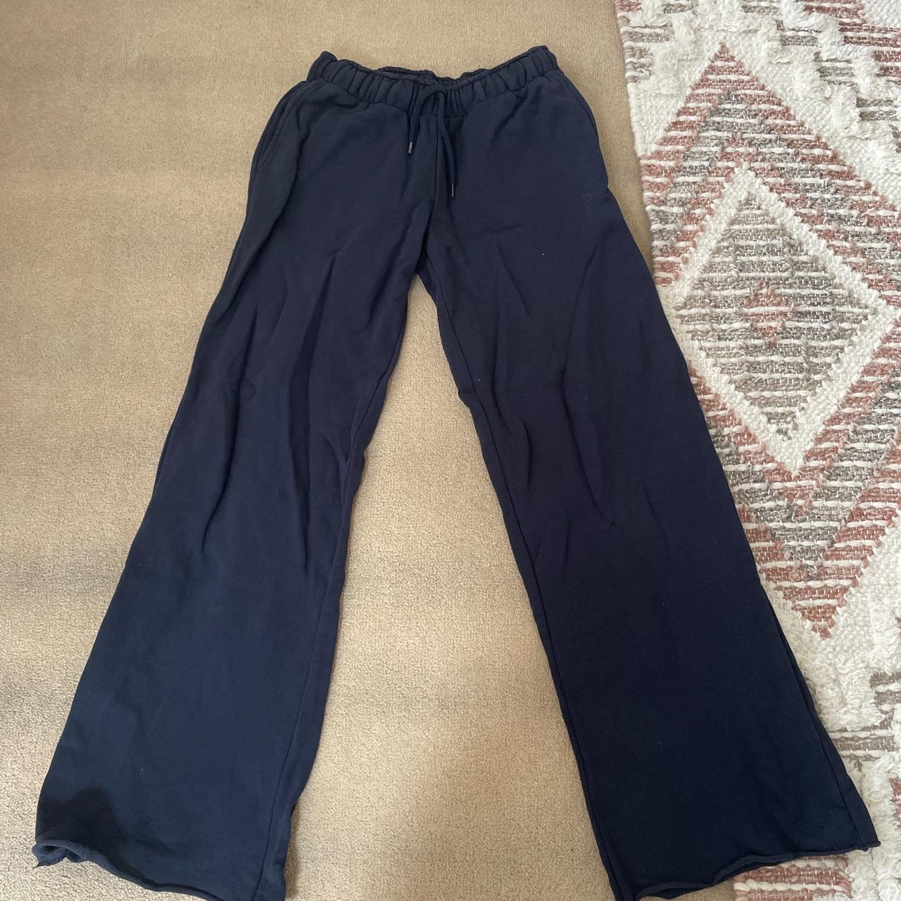 subdued navy flared tracksuit bottoms with pink star... - Depop