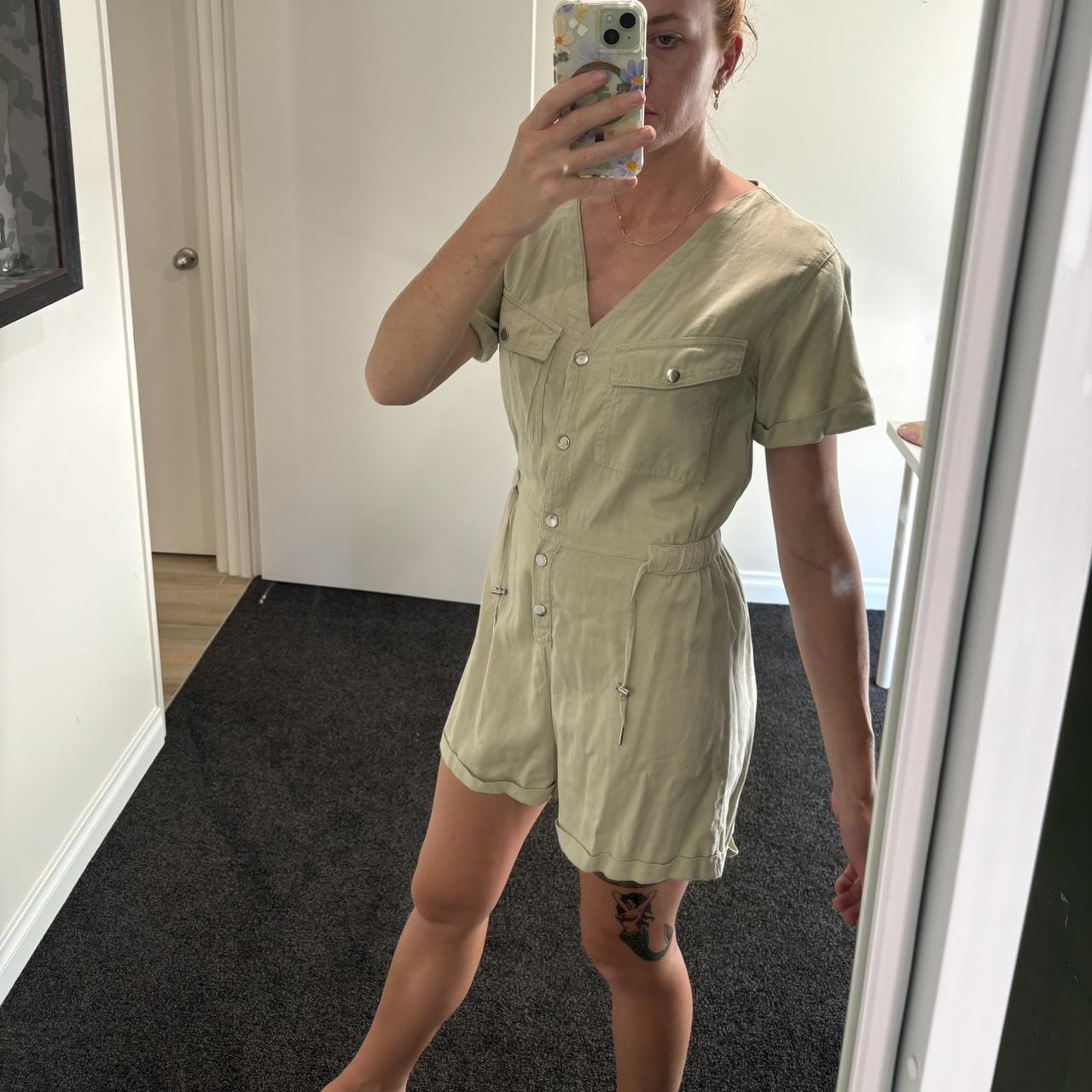 Pale green jumpsuit with press buttons at front and... Depop