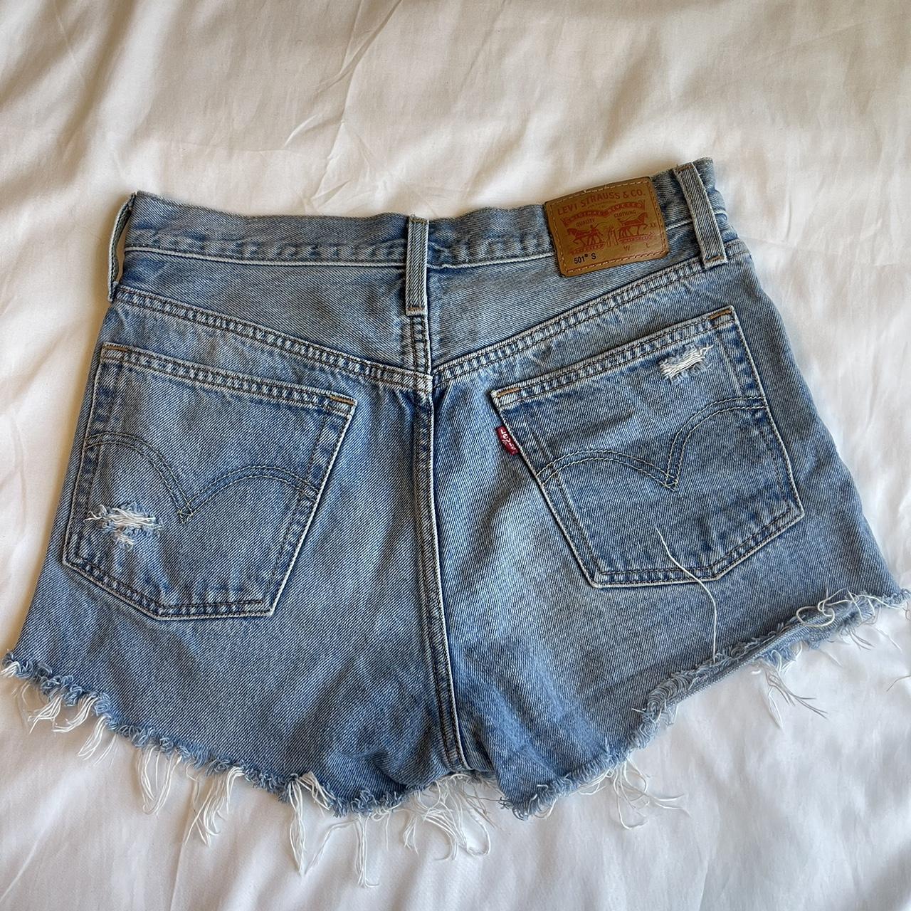 Levis medium wash denim shorts with frayed hem. Depop