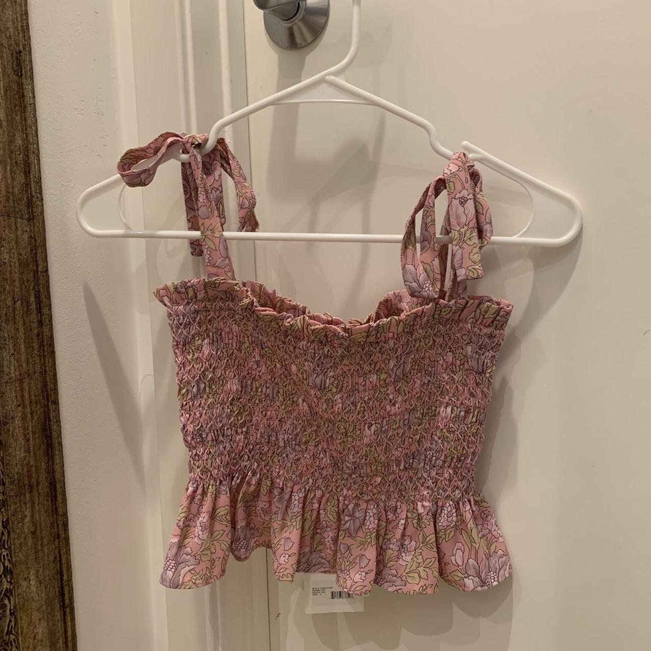 Likely pink and purple floral tank top. Super cute... Depop