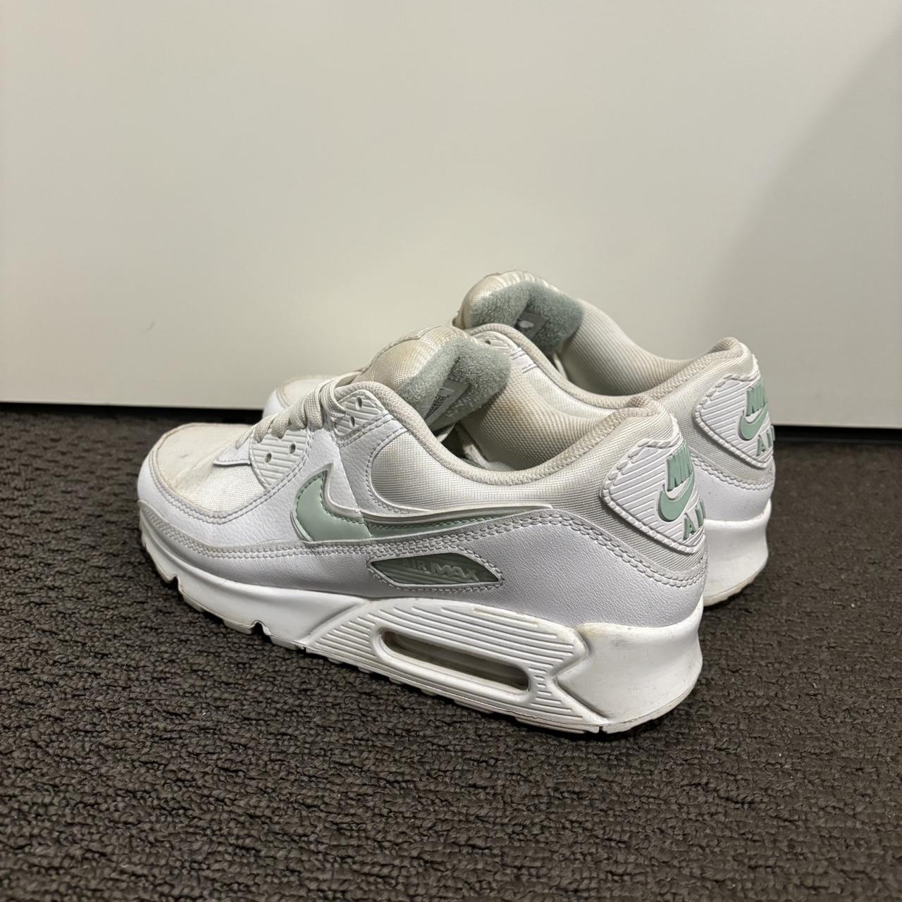 white nike shoes with green tick