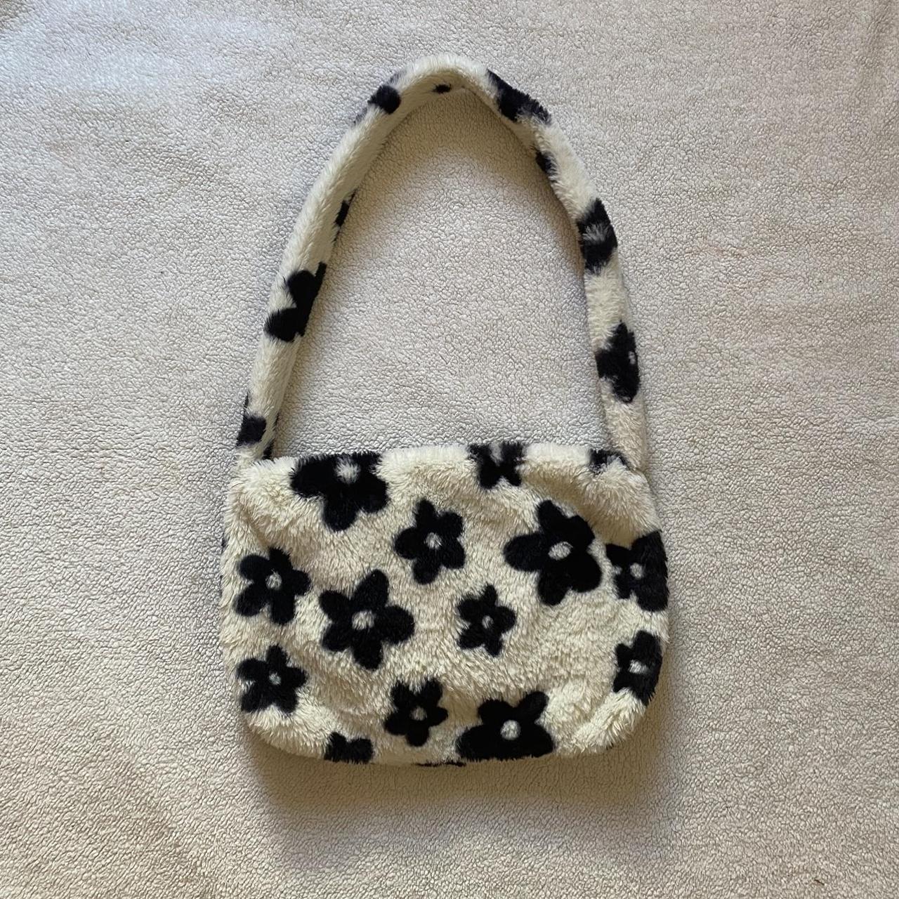 White fuzzy bag with black online flowers