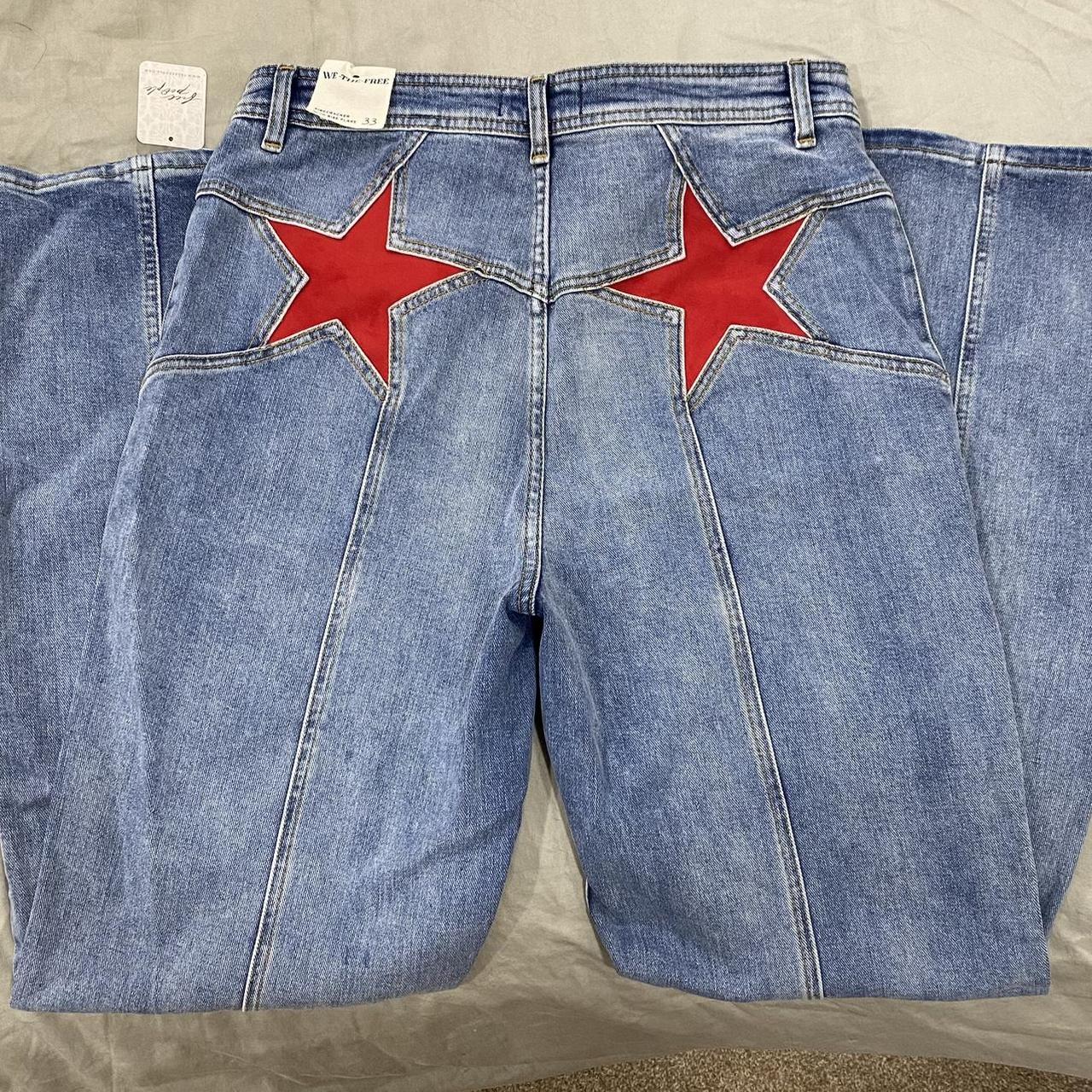 Free People Blue Jeans with red suede stars on the back.