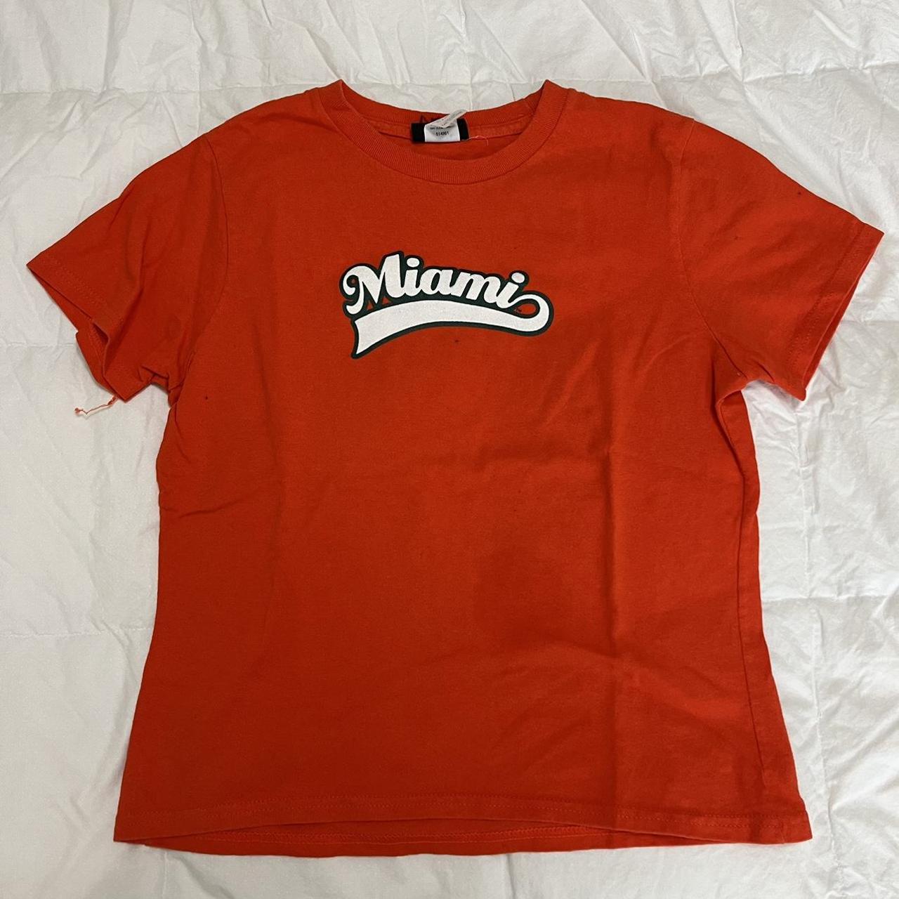 orange shirt with white writing