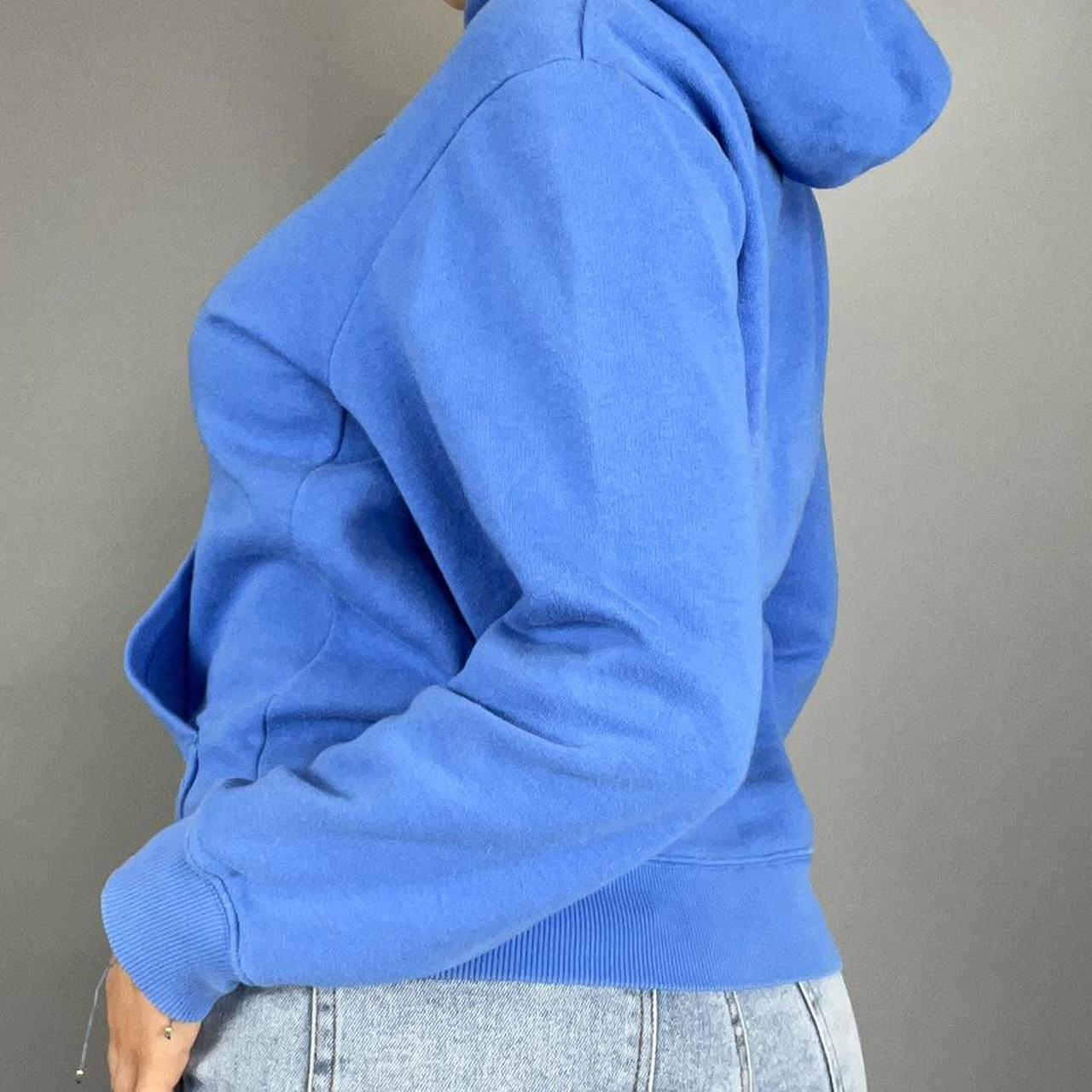 white nike hoodie with blue swoosh